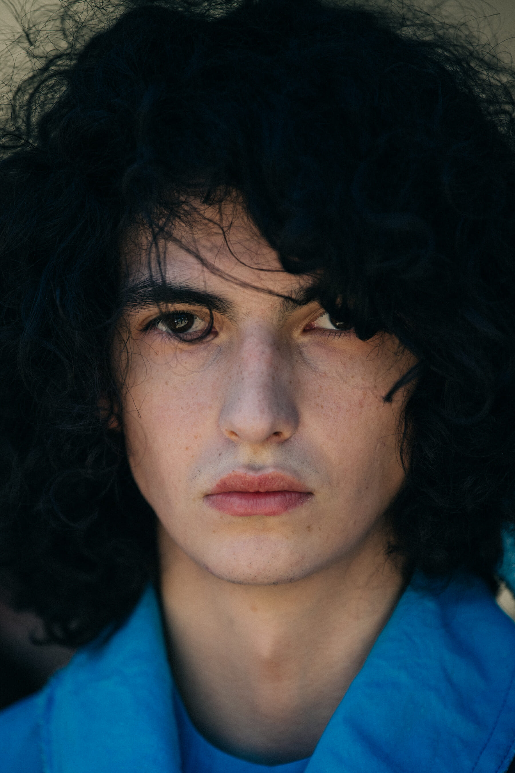 Portrait of model with thick dark hair