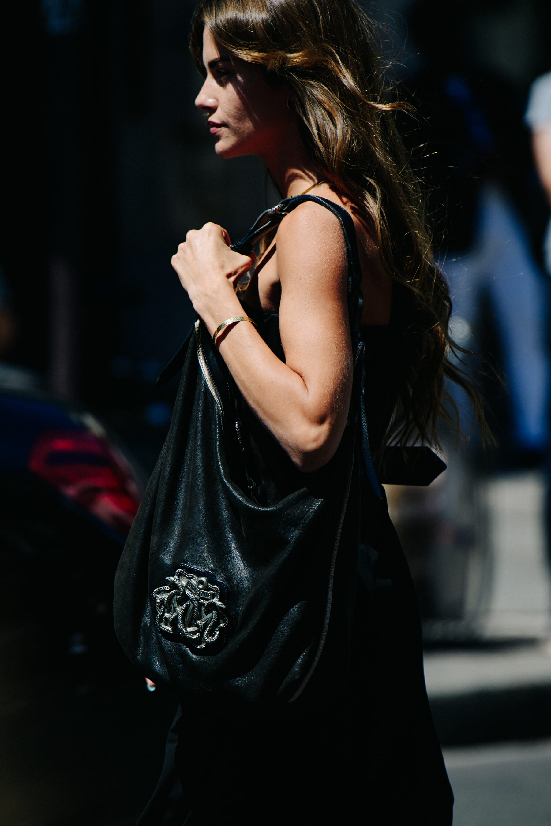 Woman carrying black leather bag