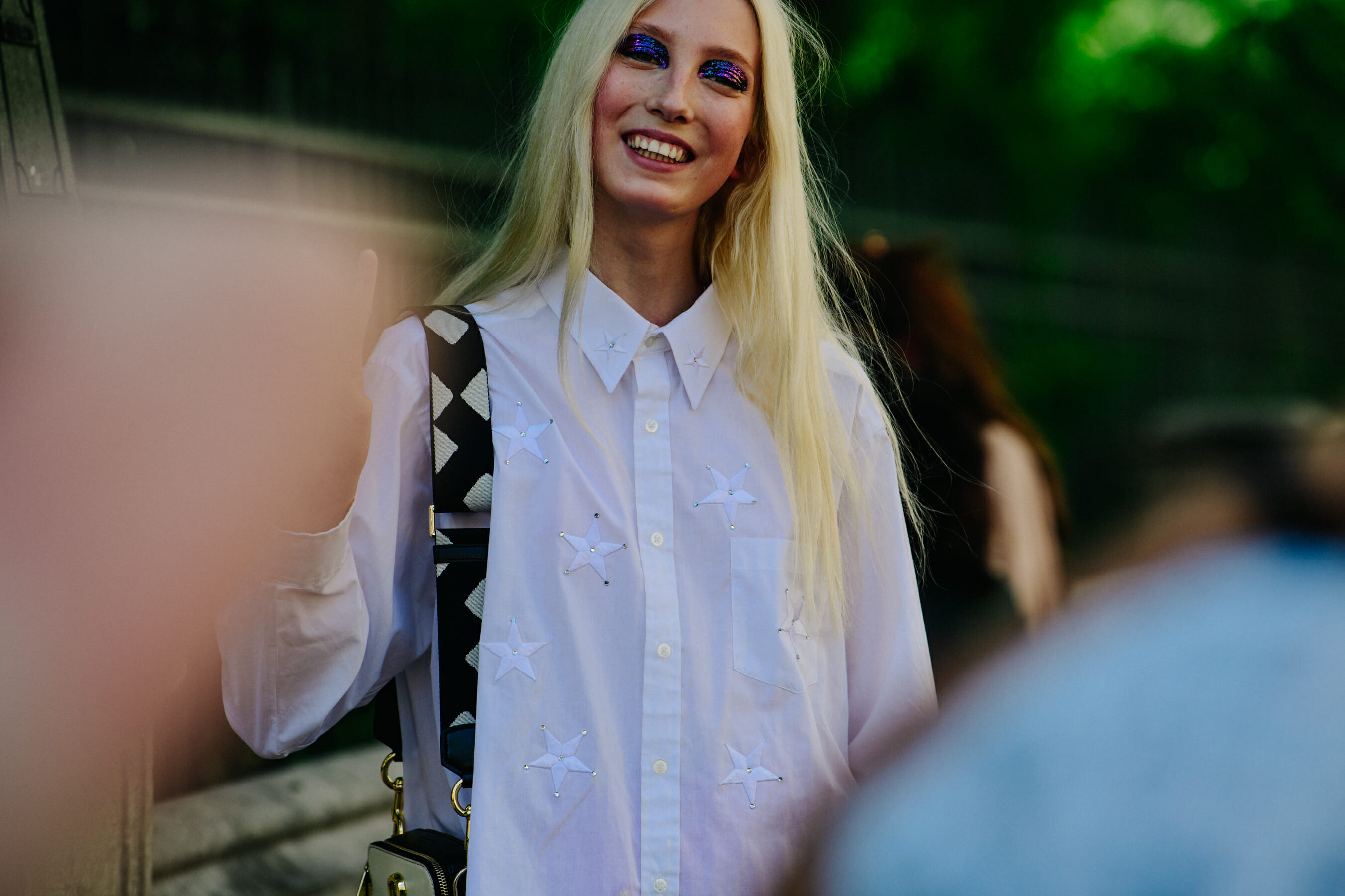 Model wearing white star shirt