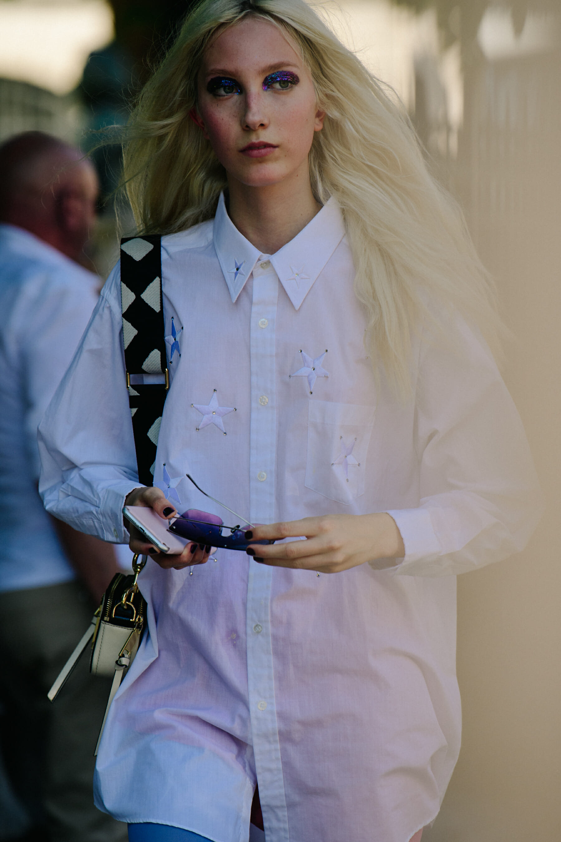 Model wearing white star shirt