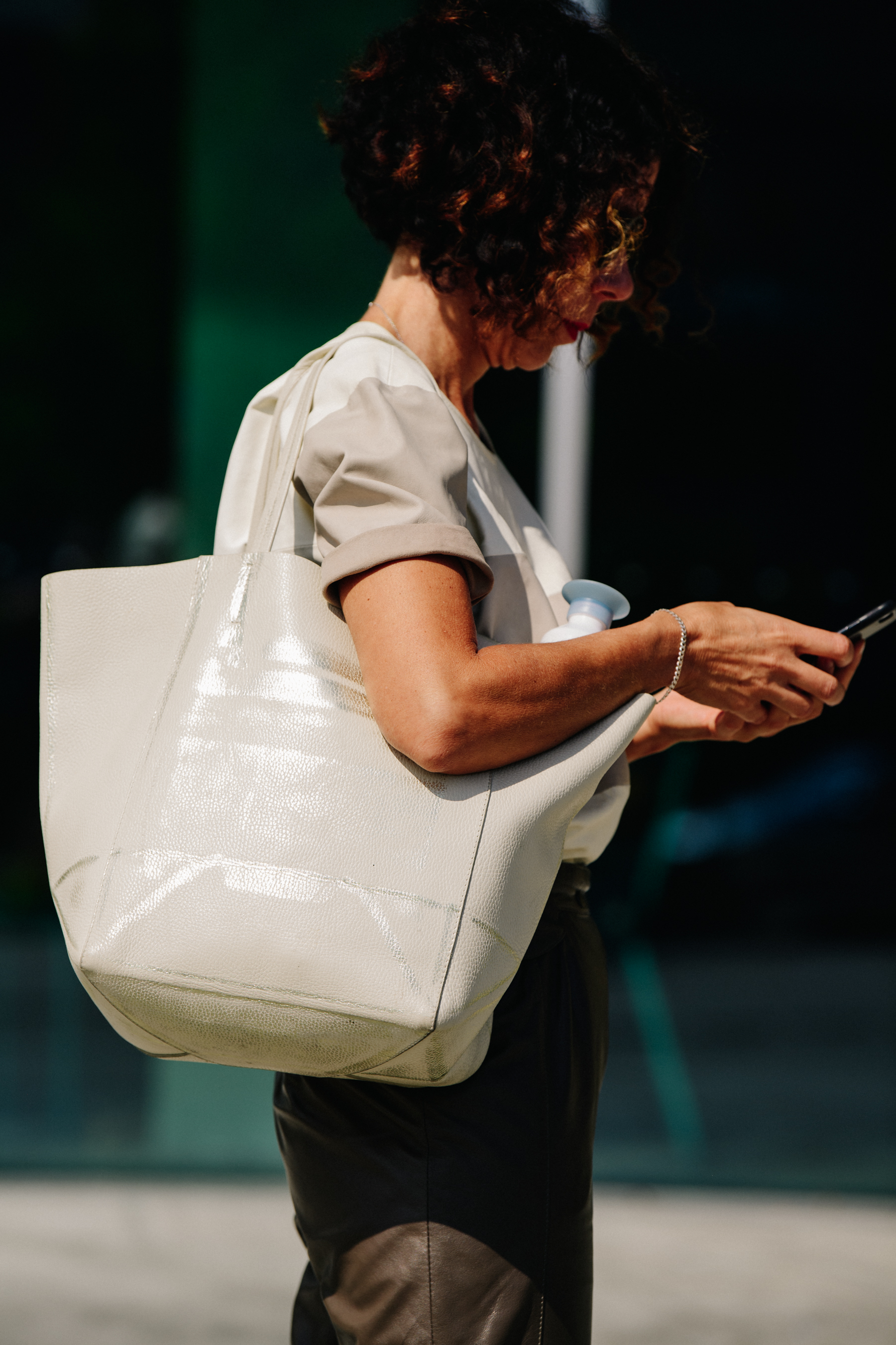 Woman carrying cream bag