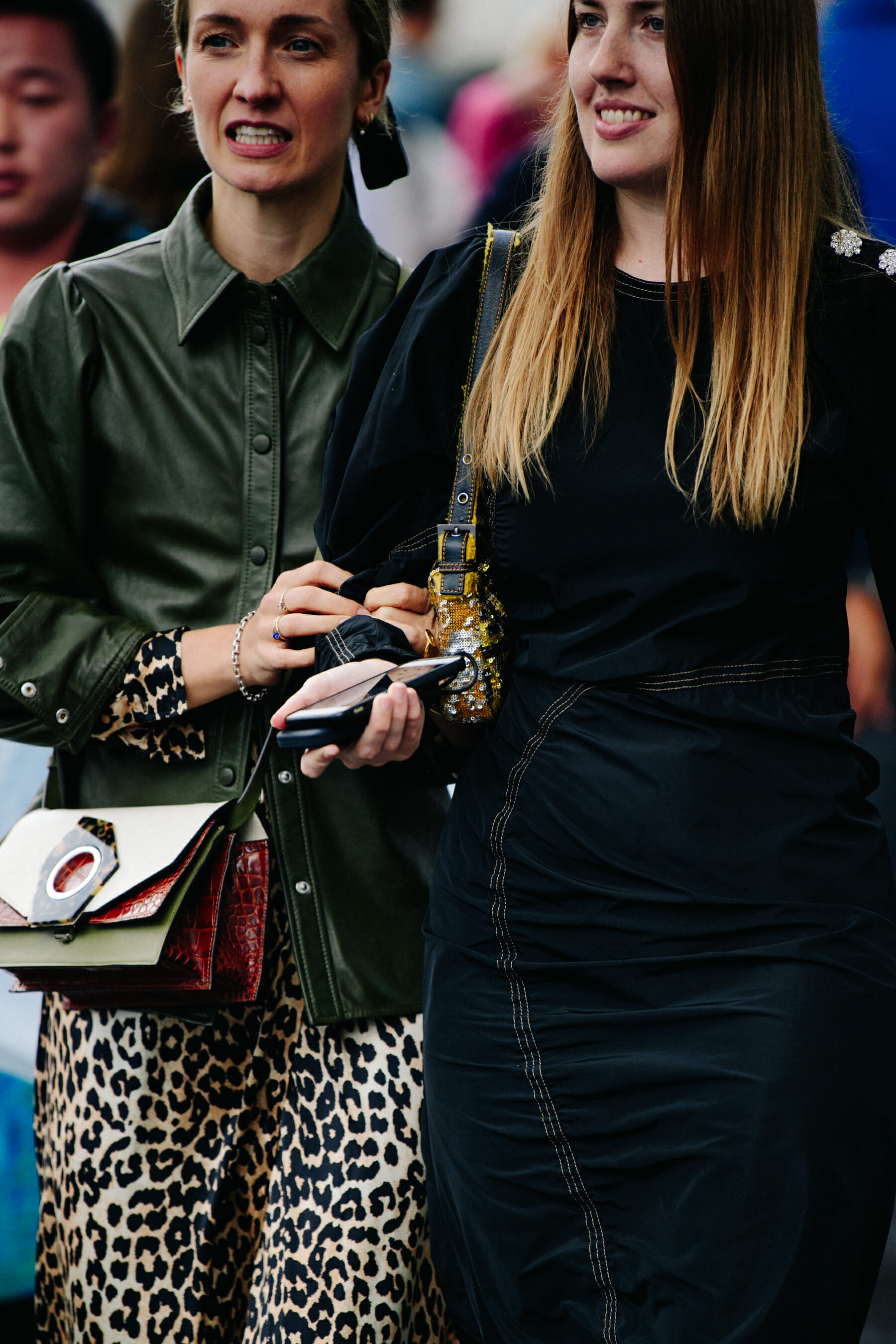 Two women wearing dark clothing