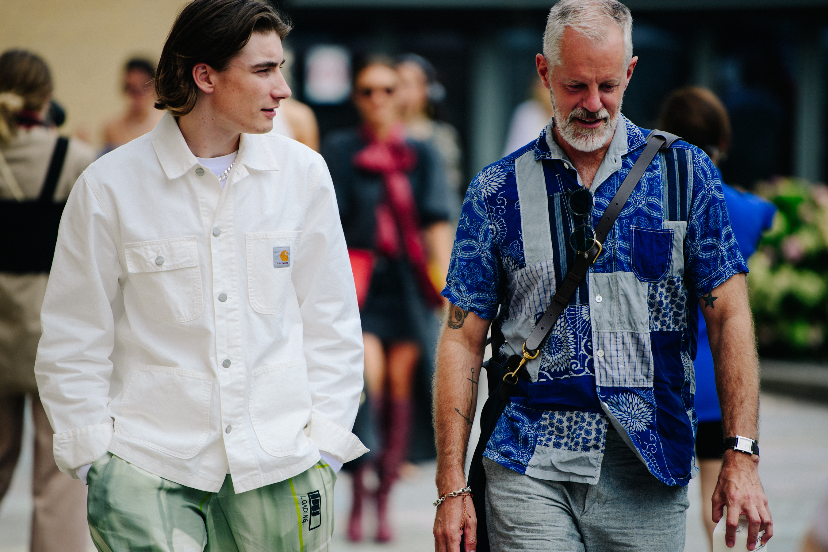 Two men wearing white and blue shirts