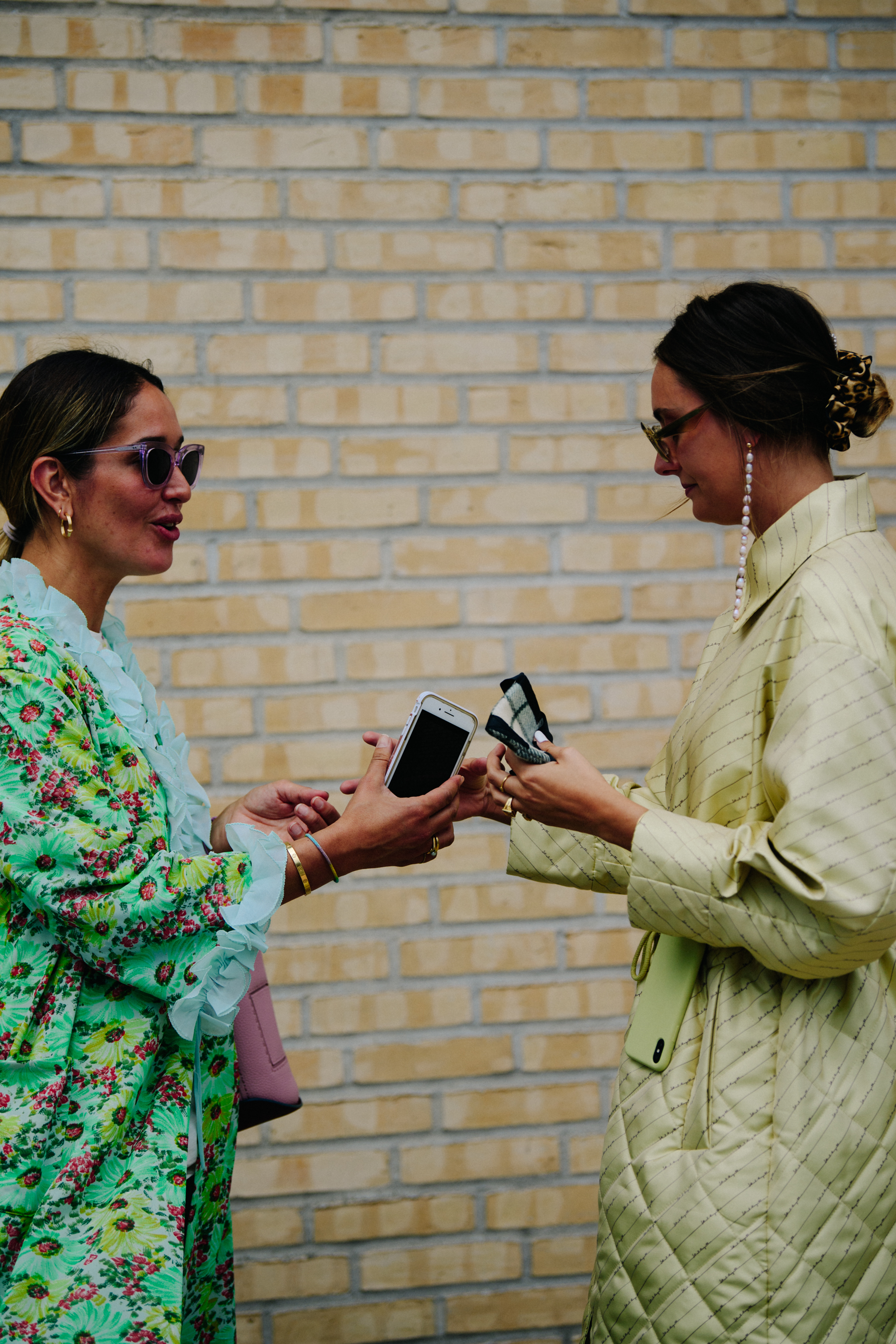 Two women wearing long coats