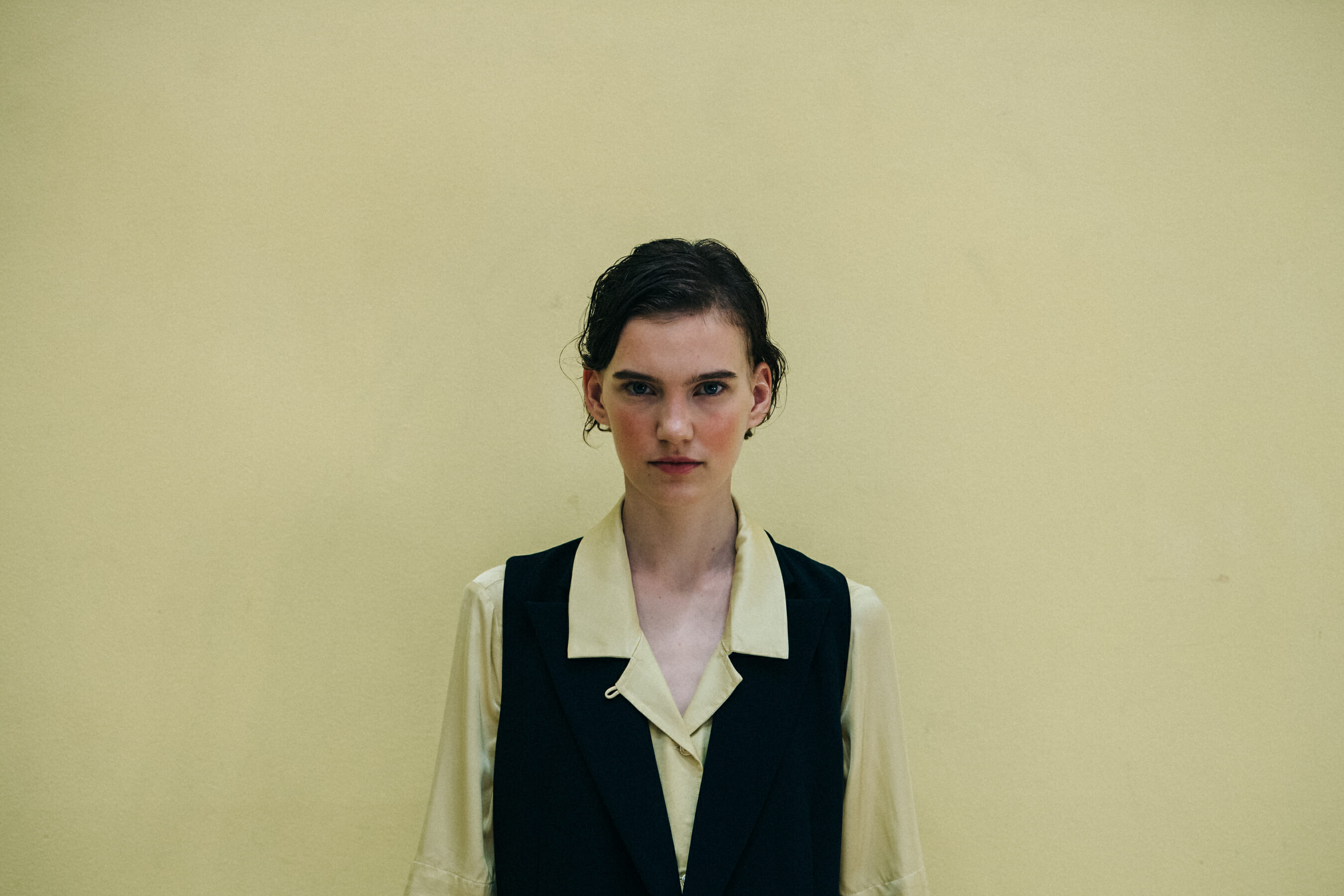 Model wearing black waistcoat at Holzweiler