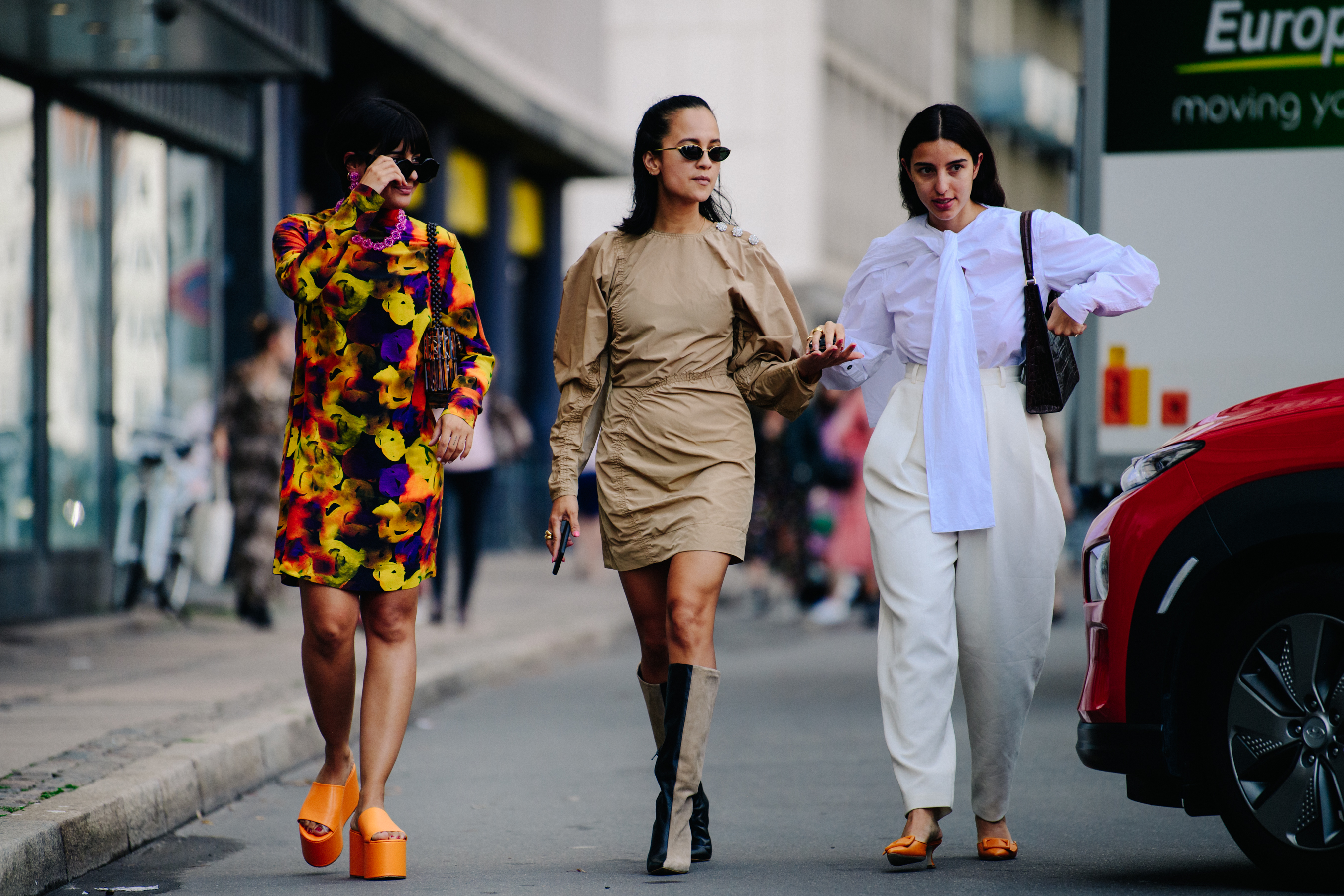 Three women wearing light dresses
