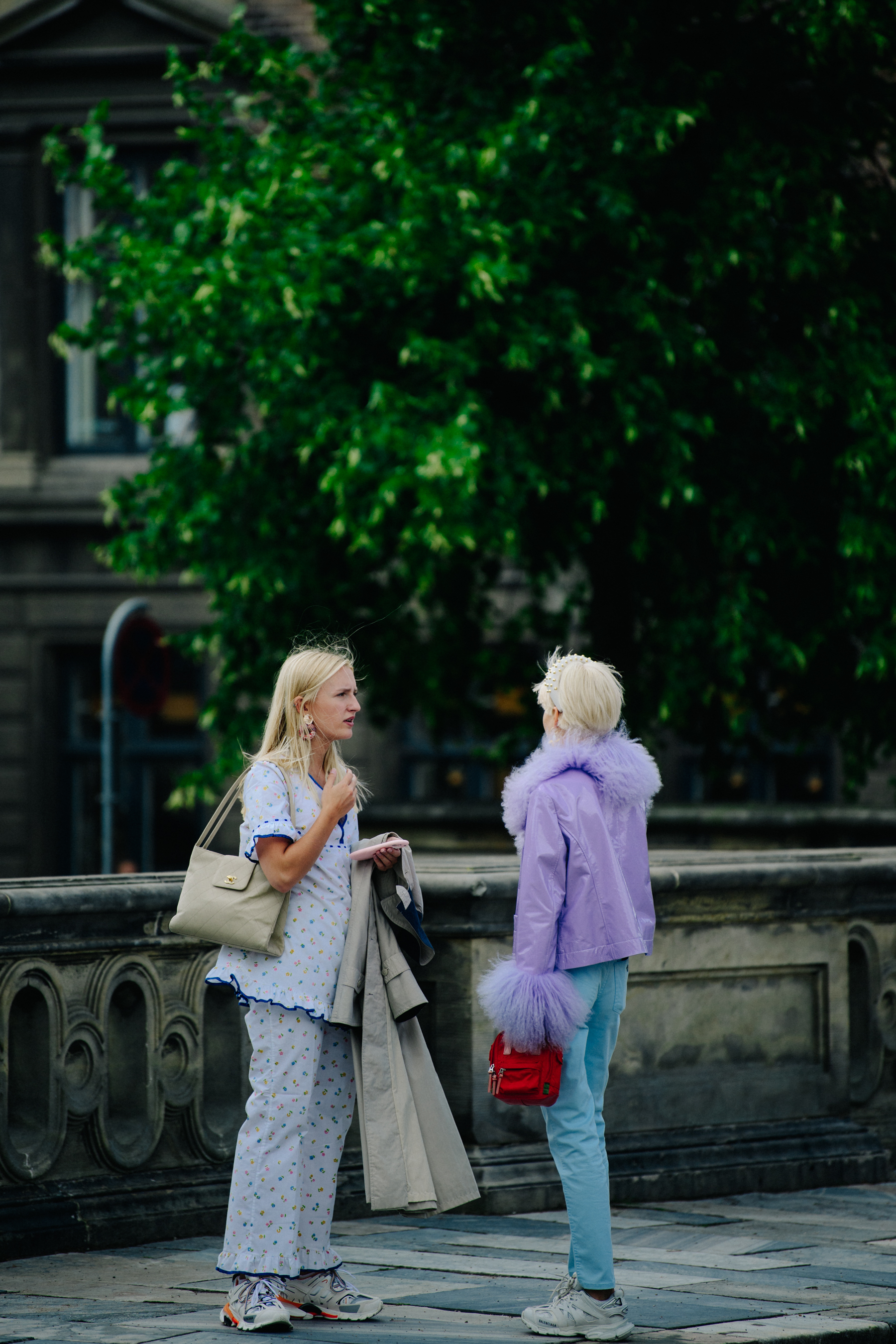 Two women wearing purple