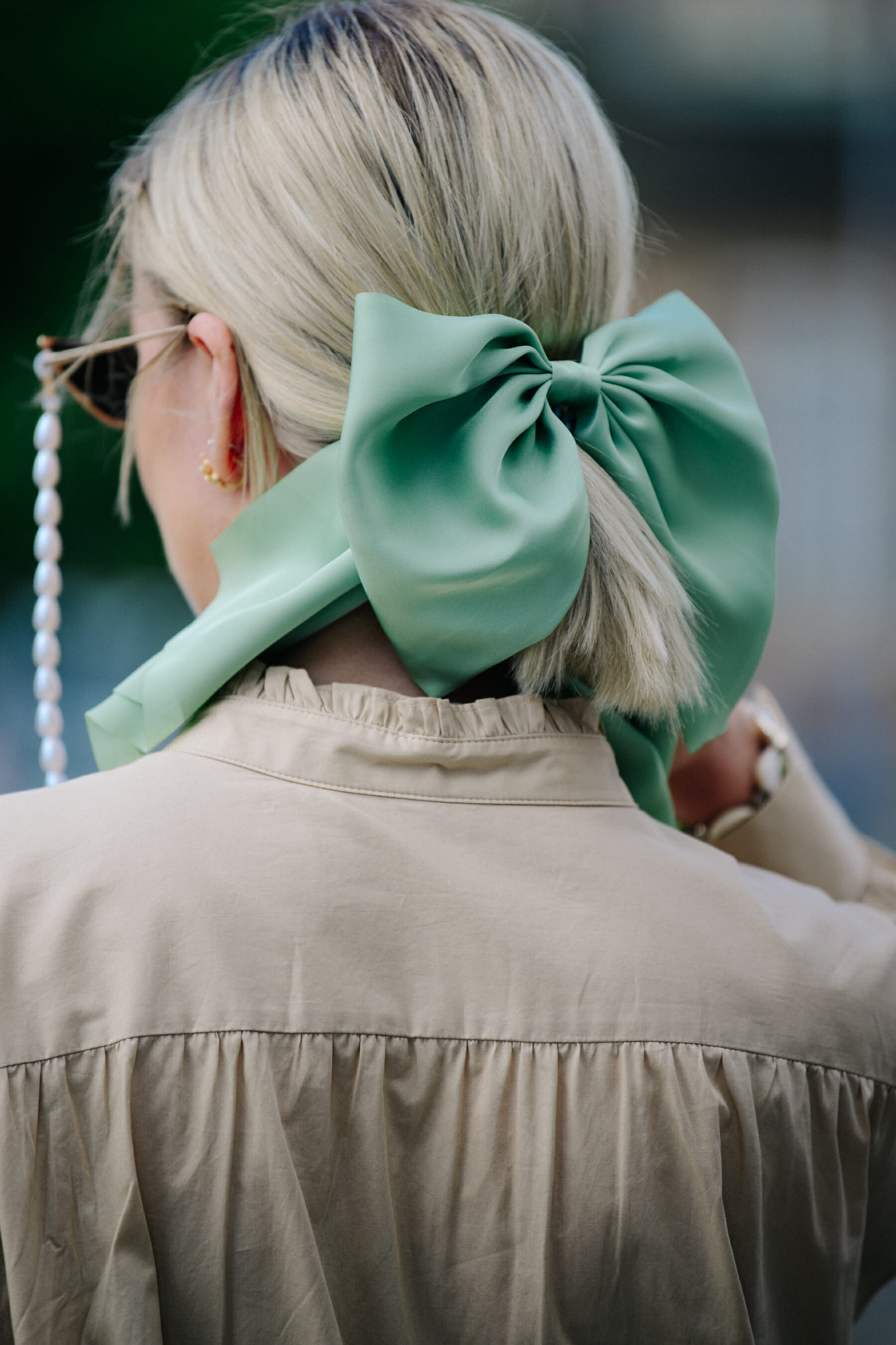 Woman wearing green hair bow
