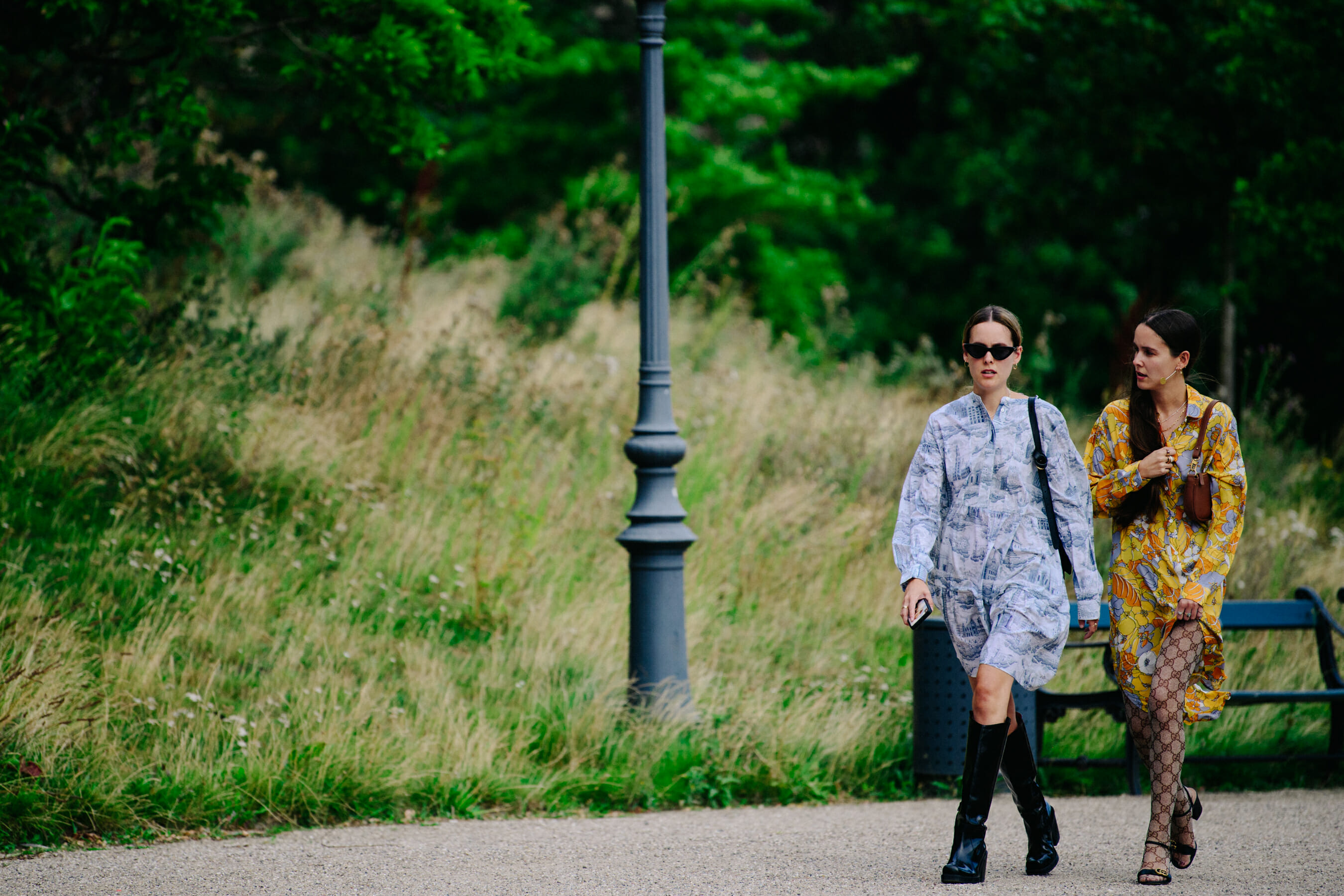 Two women wearing patterned dresses
