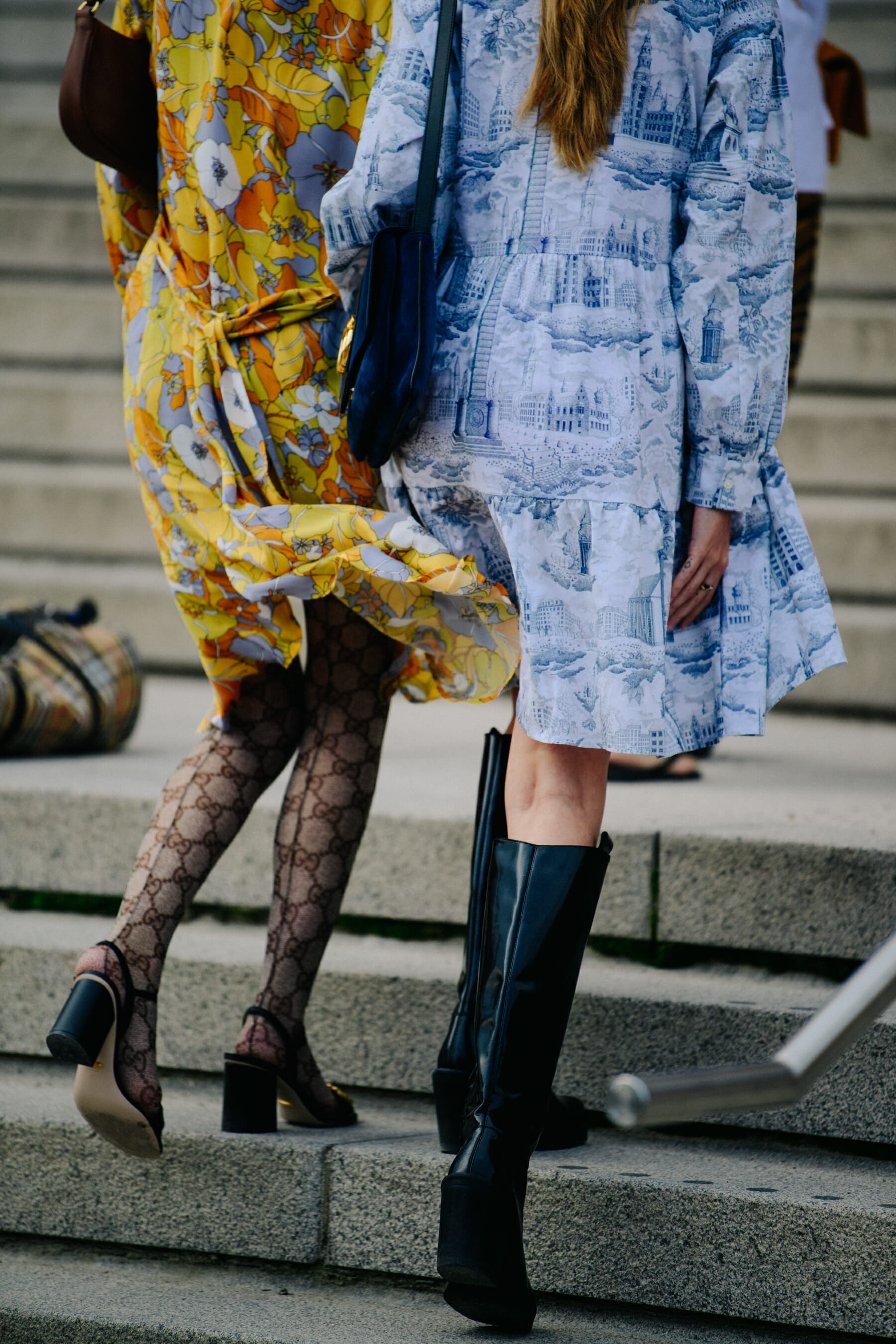 Two women wearing patterned dresses