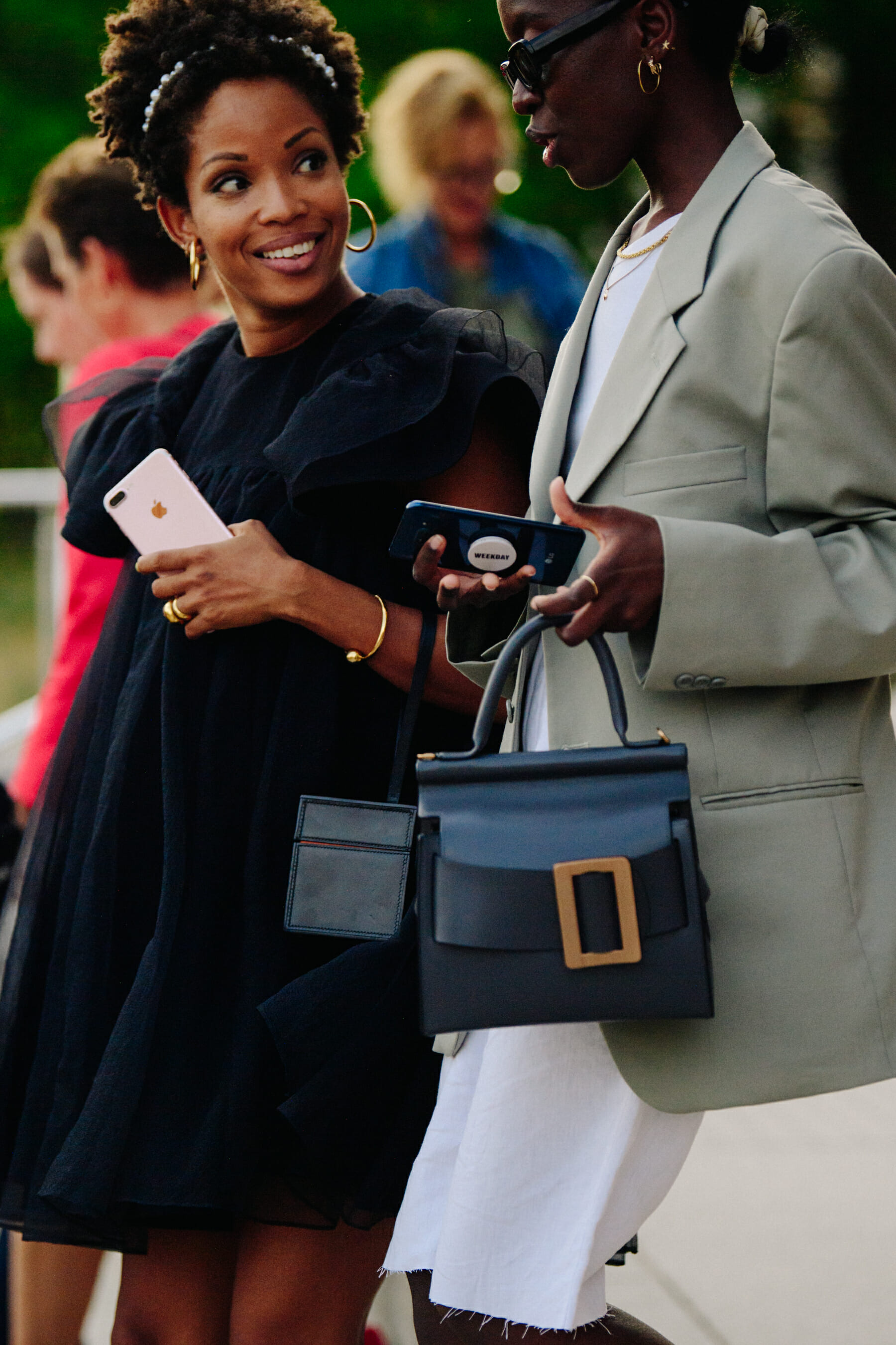 Two women wearing smart jackets