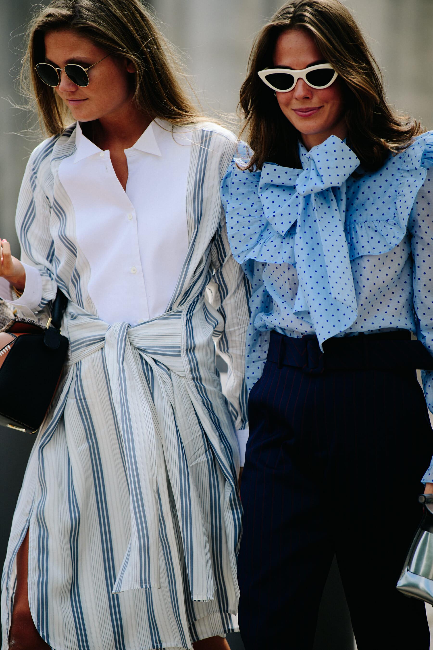Two women wearing blue tops