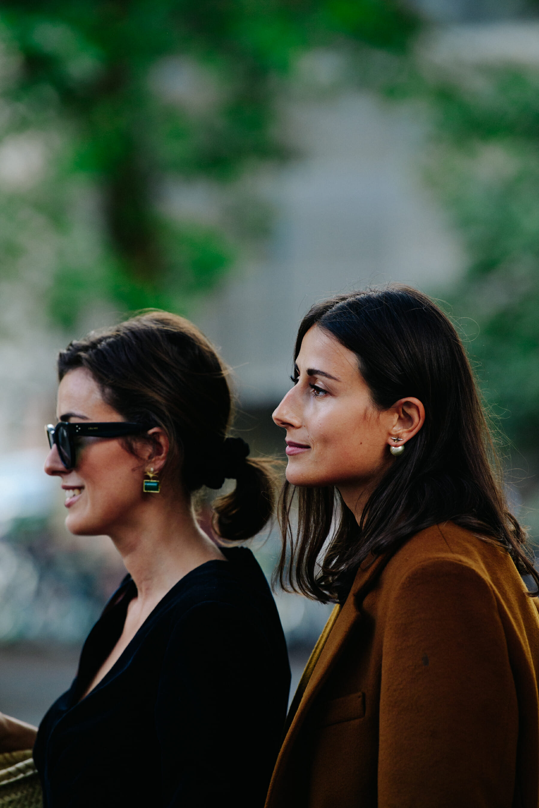 Two women wearing black and brown