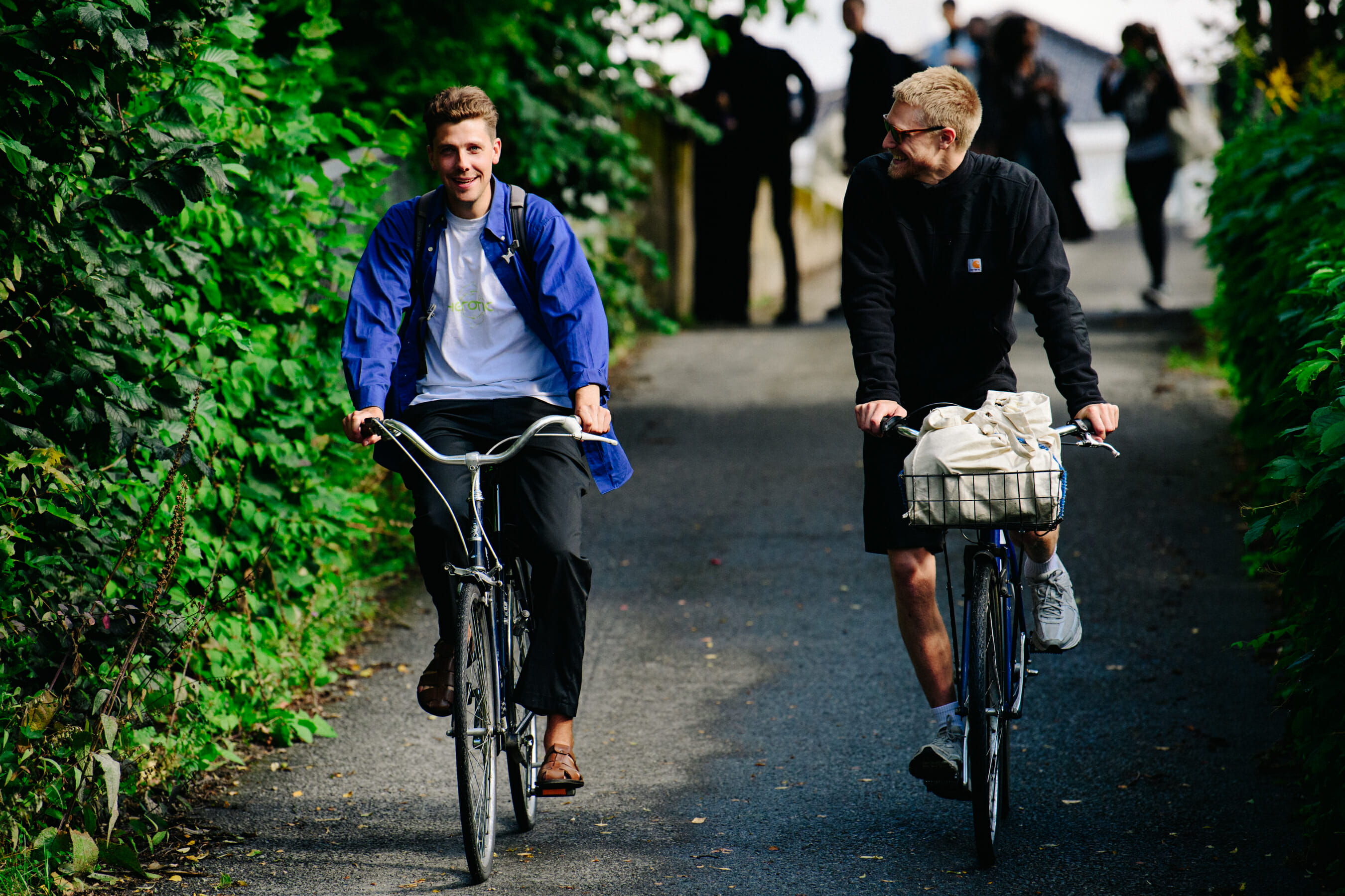 Two men riding bicycles