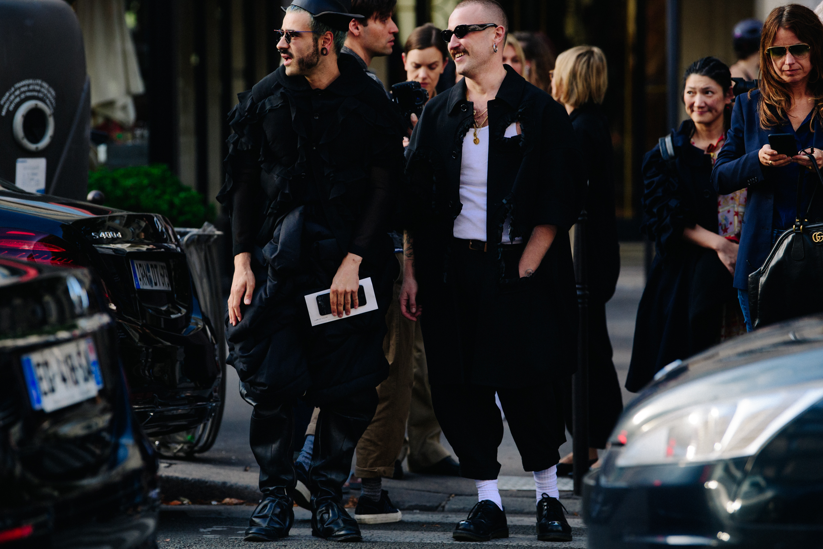 Two men wearing black outfits