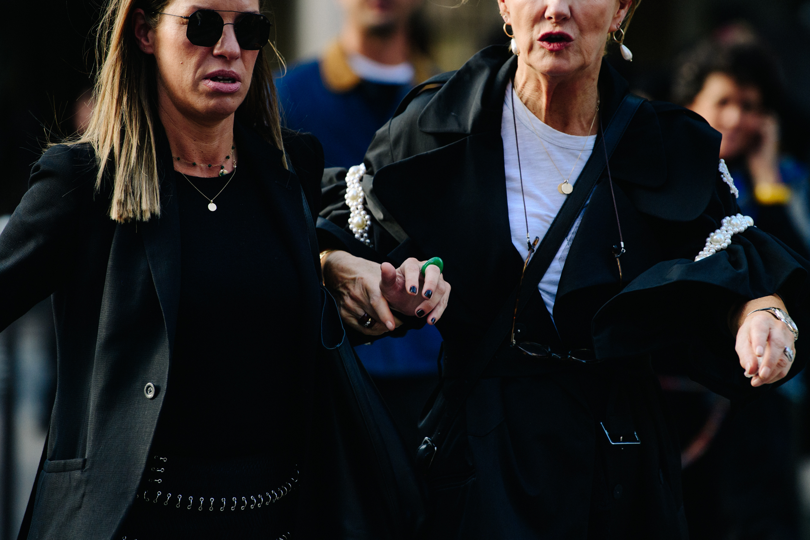 Two women wearing black outfits