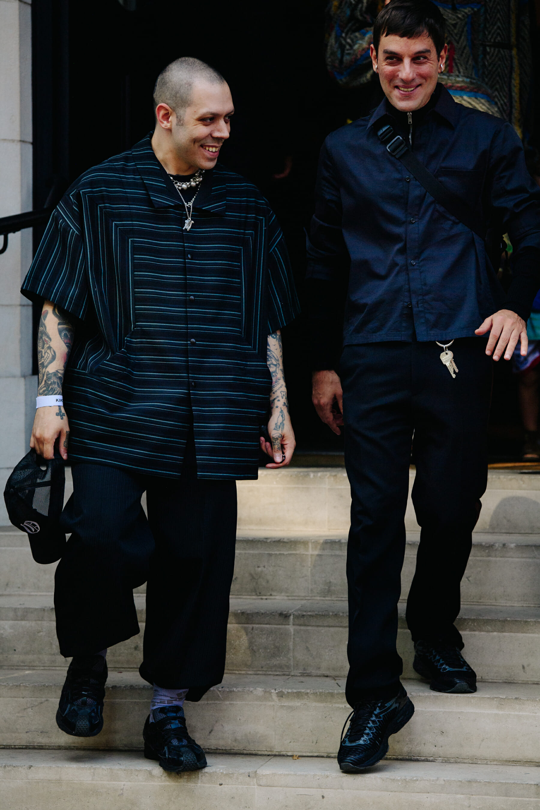 Two men wearing dark clothing
