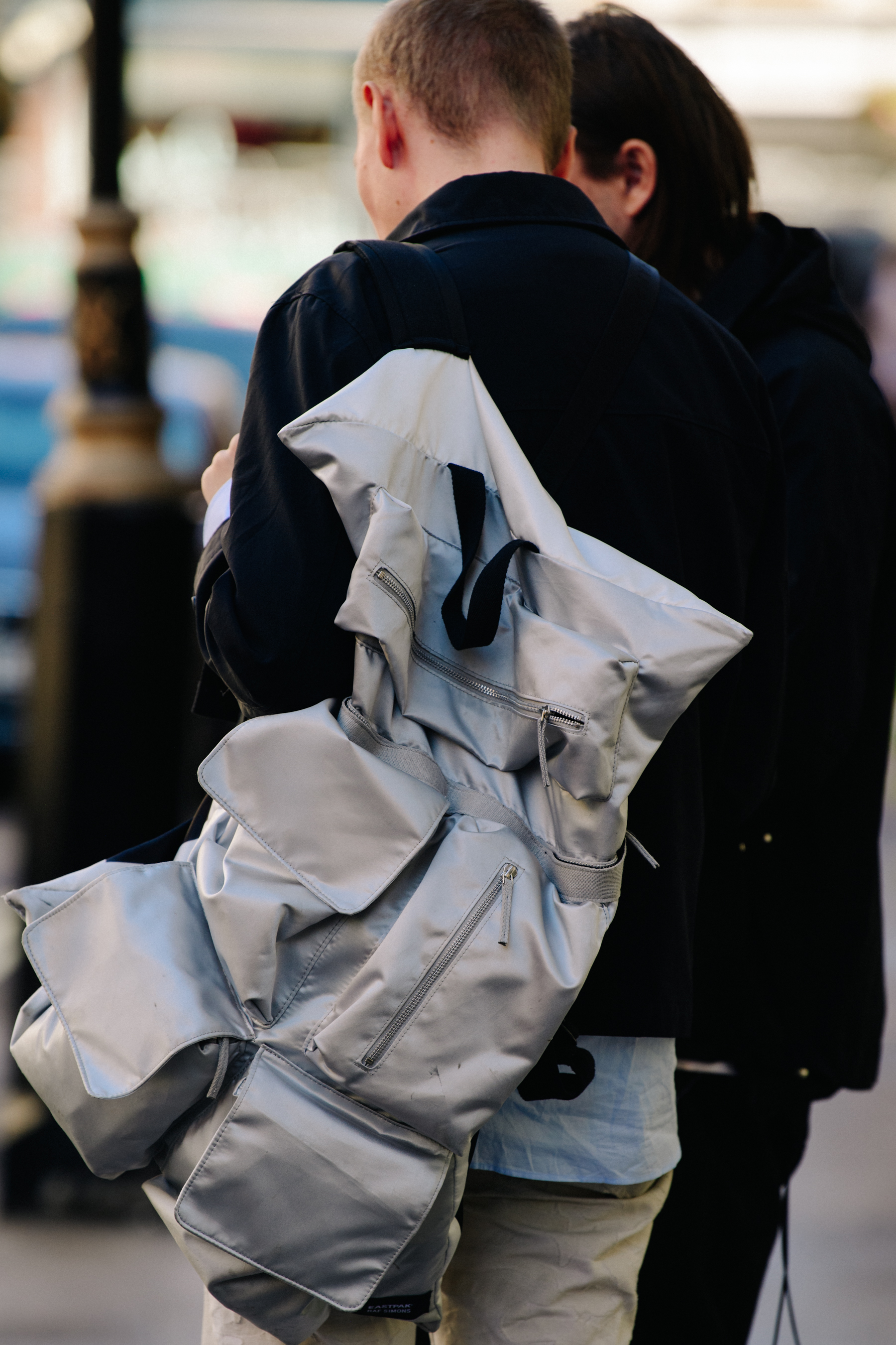 Man wearing grey backpack