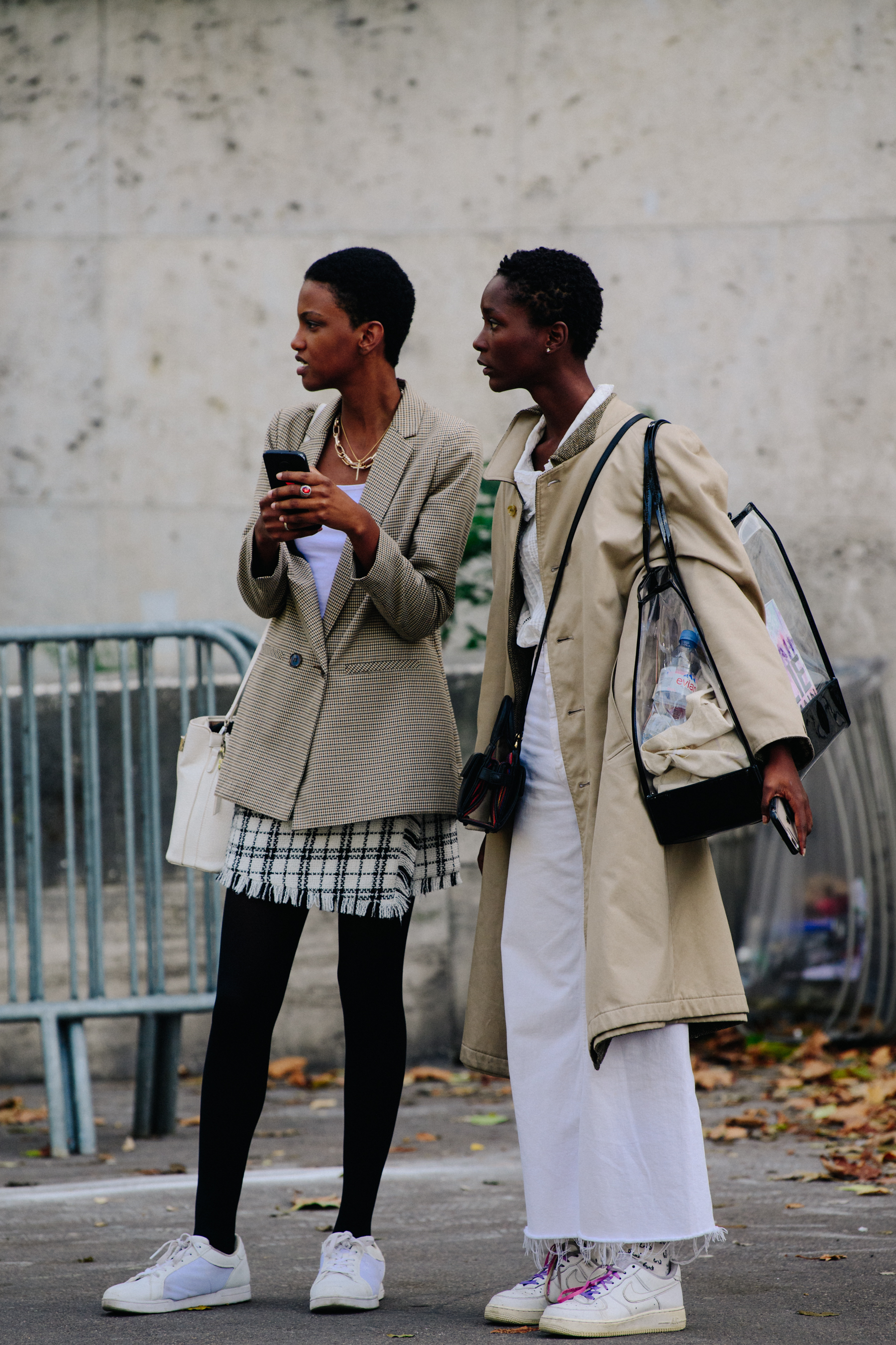 Two models wearing tan coats