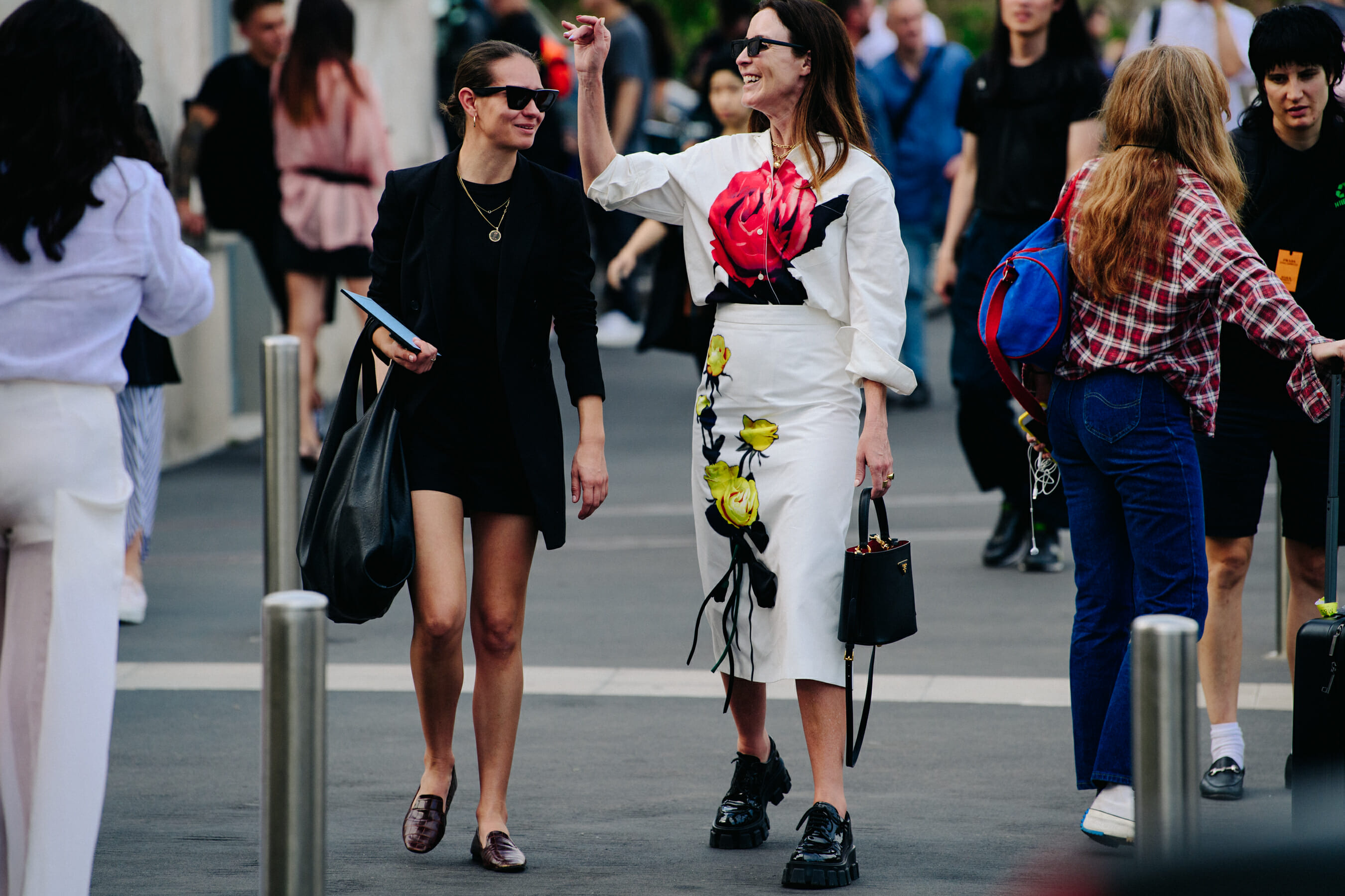 Two women wearing skirts