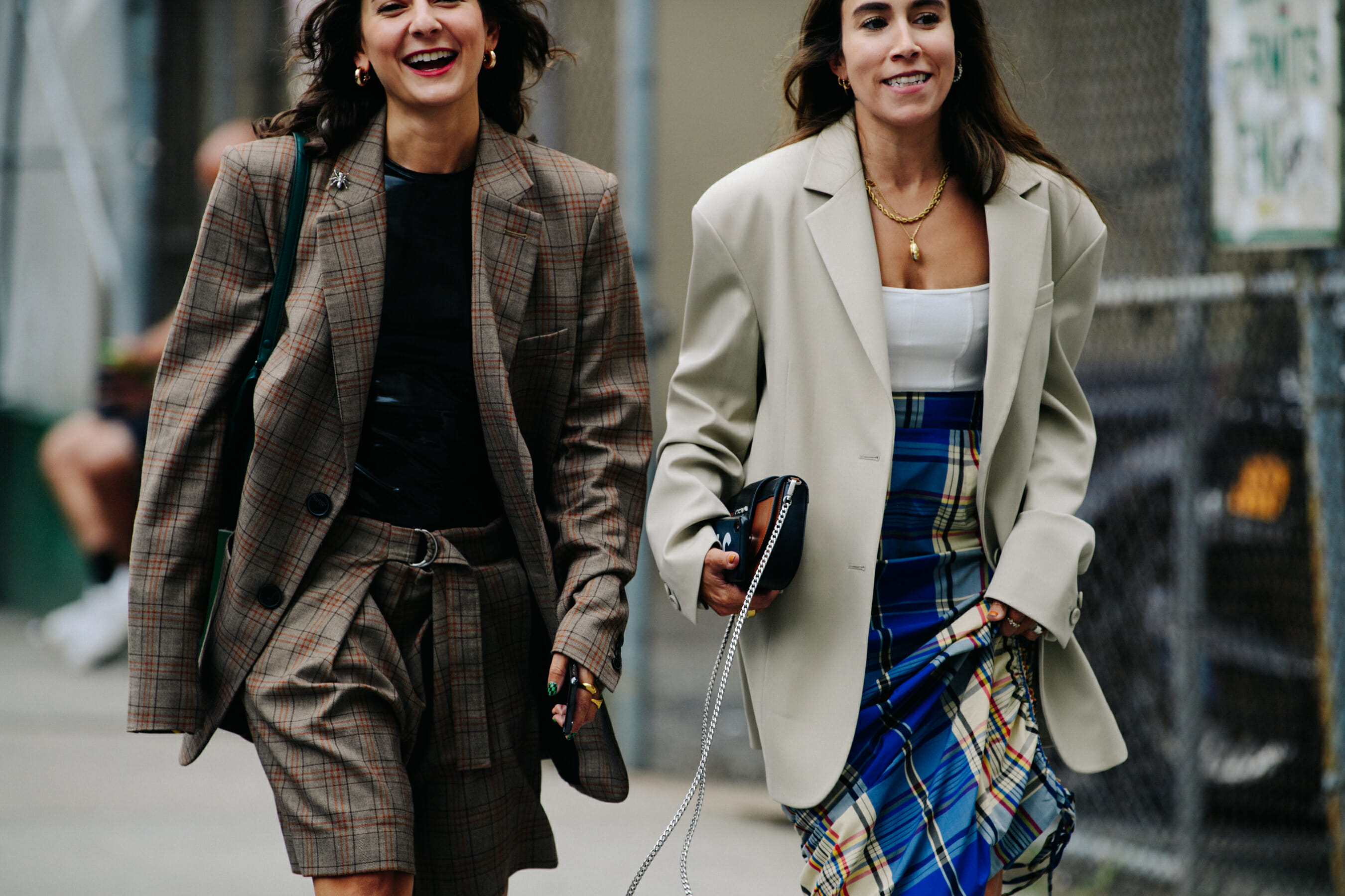 Two women wearing large blazers