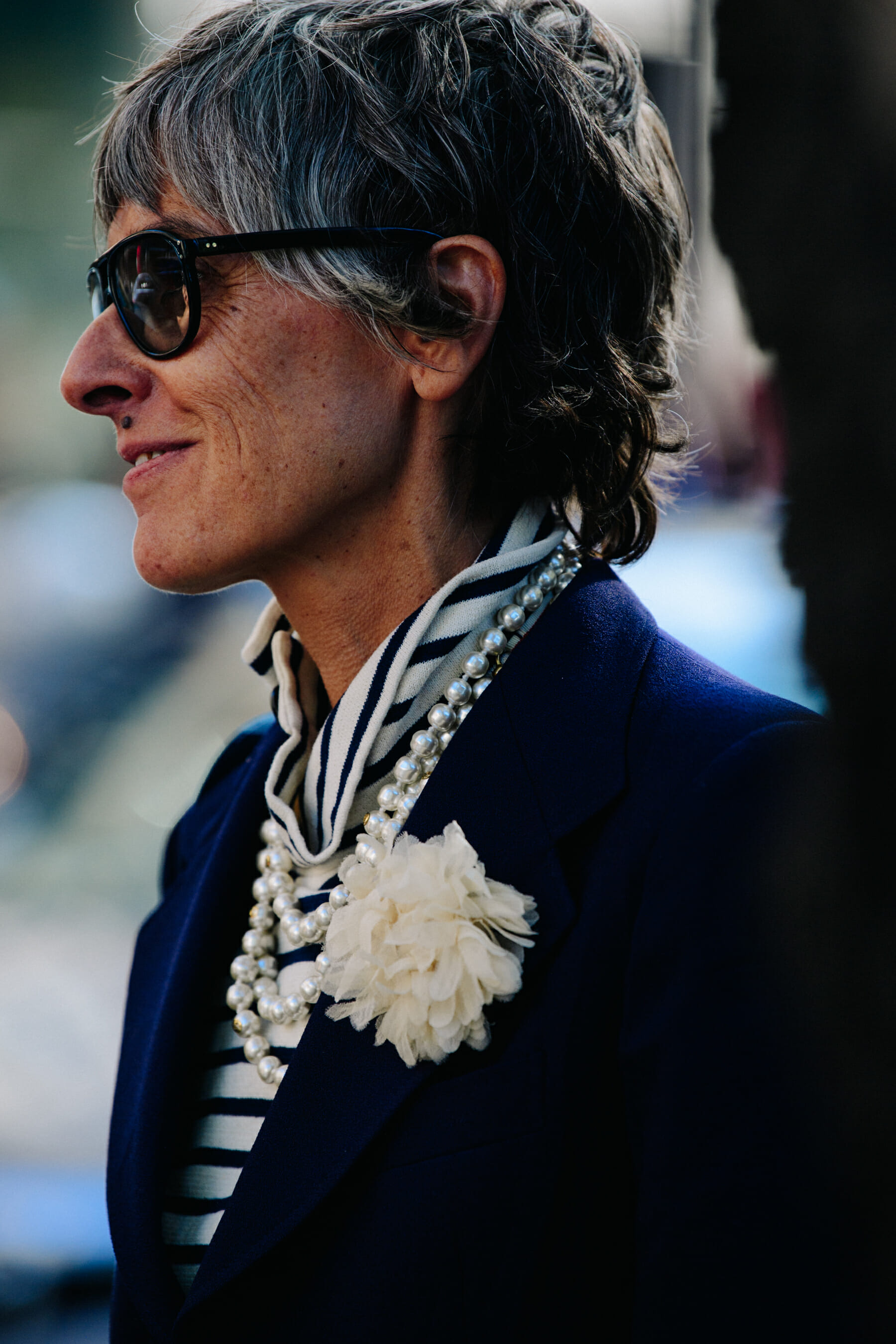 Woman wearing white flower brooch