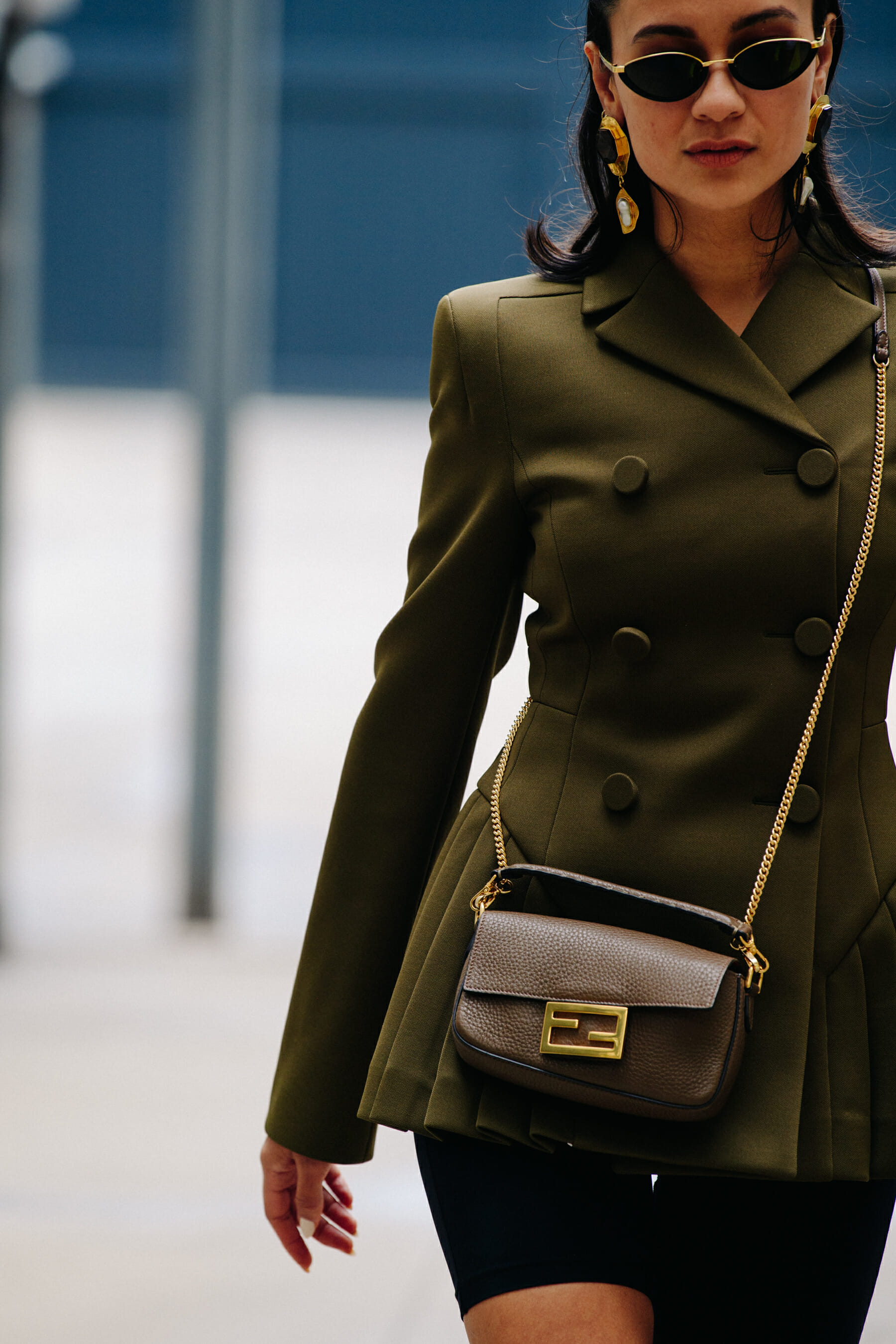 Woman wearing green double breasted coat