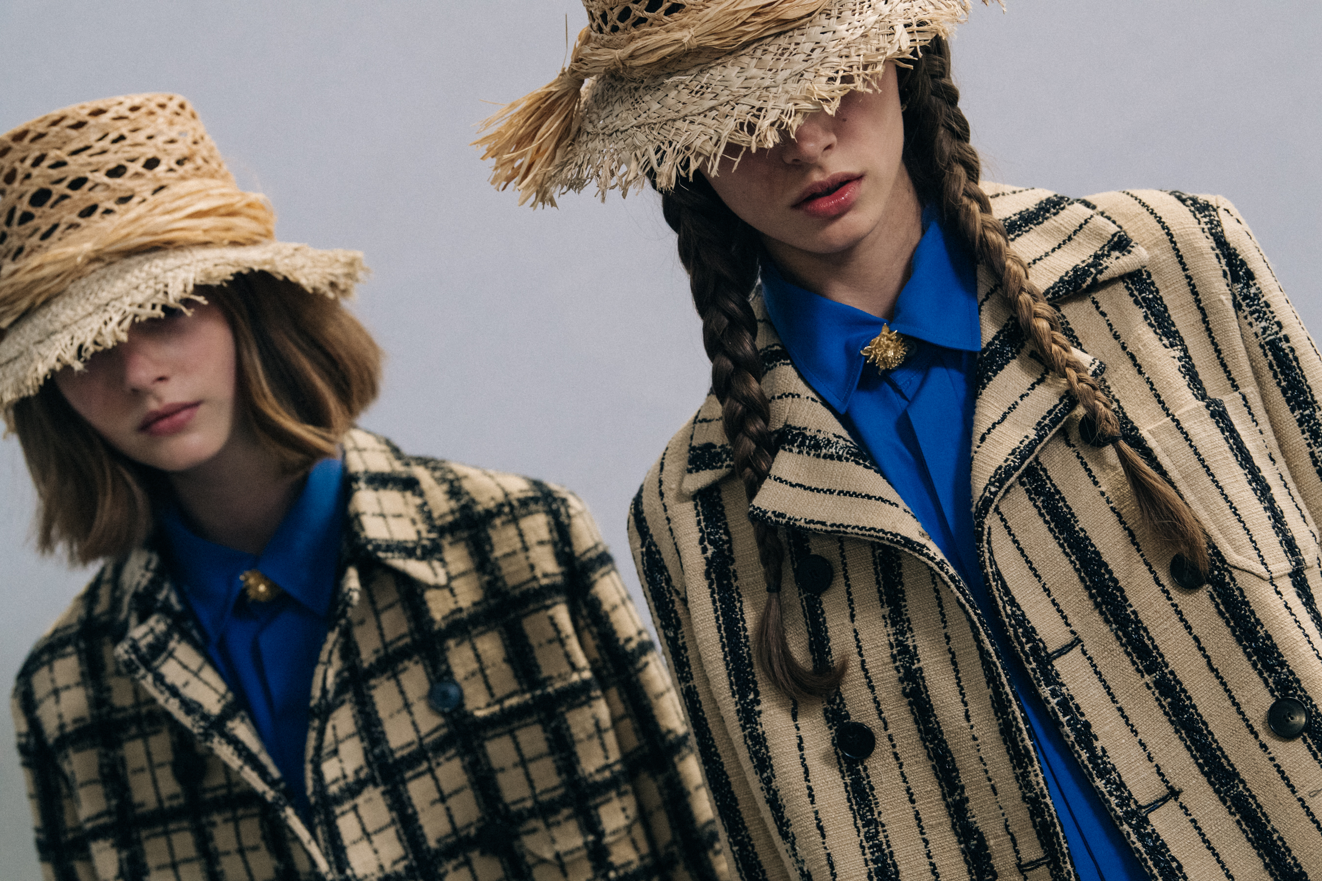 Models wearing straw hats at Christian Dior