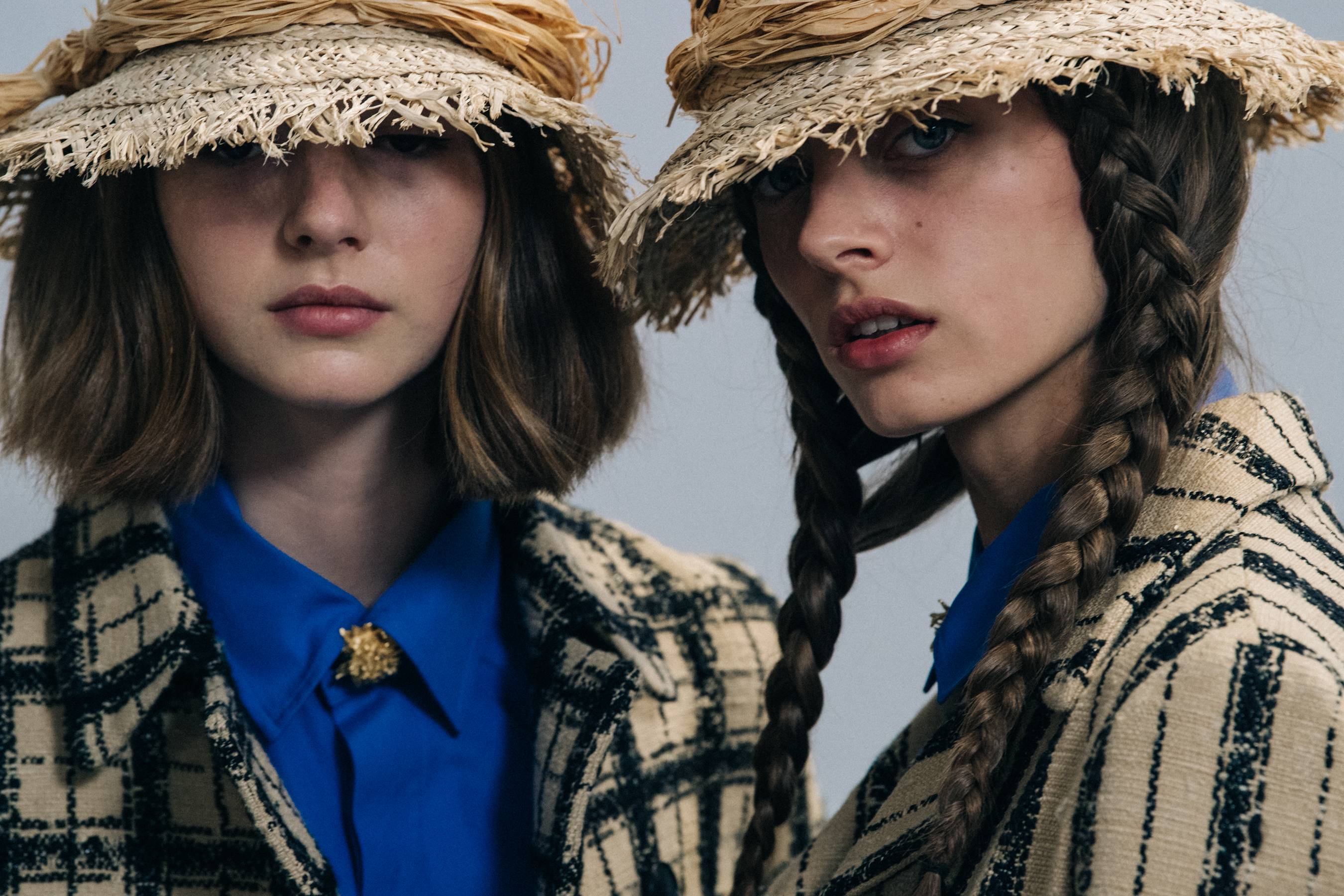 Models wearing straw hats at Christian Dior