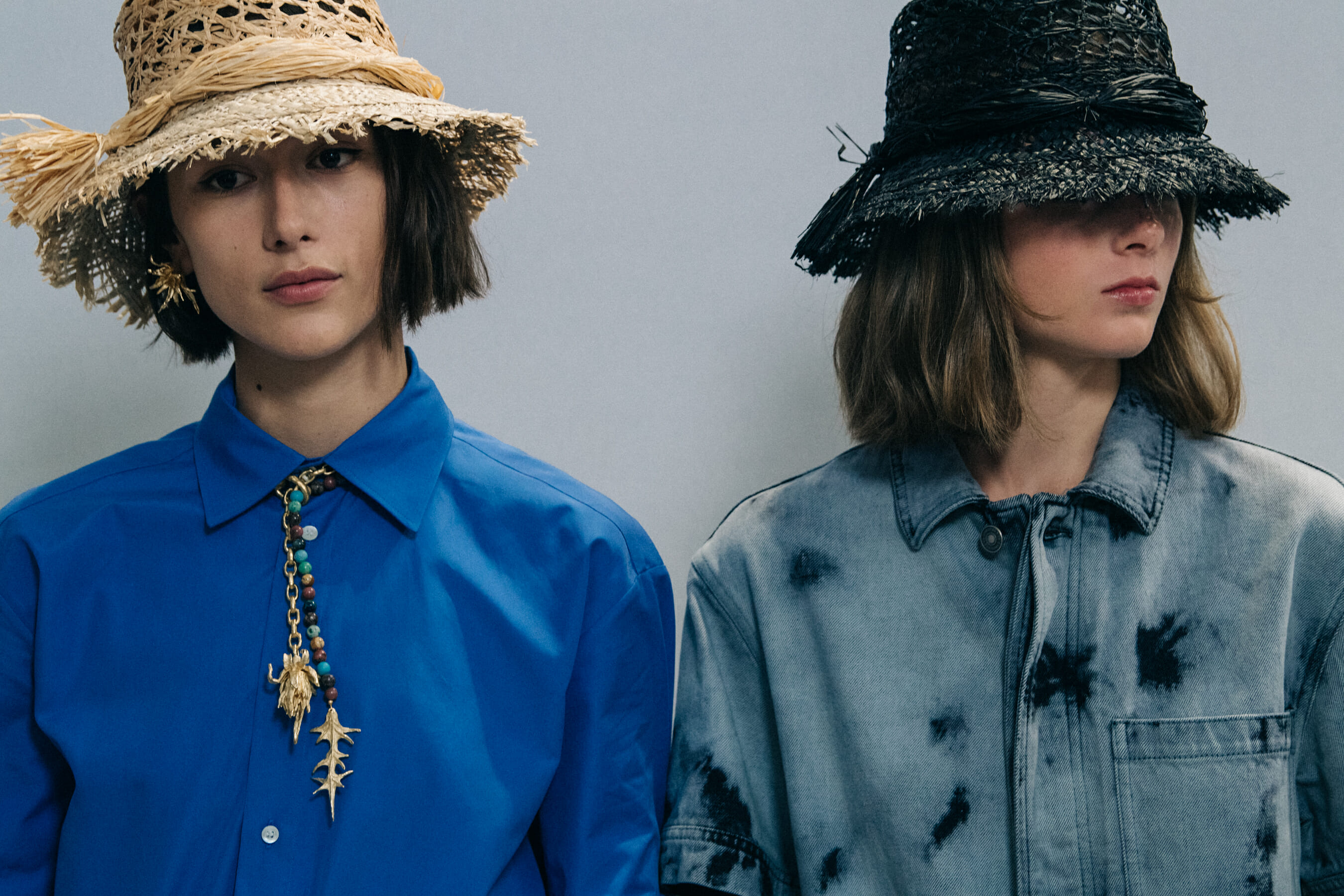 Models wearing straw hats at Christian Dior