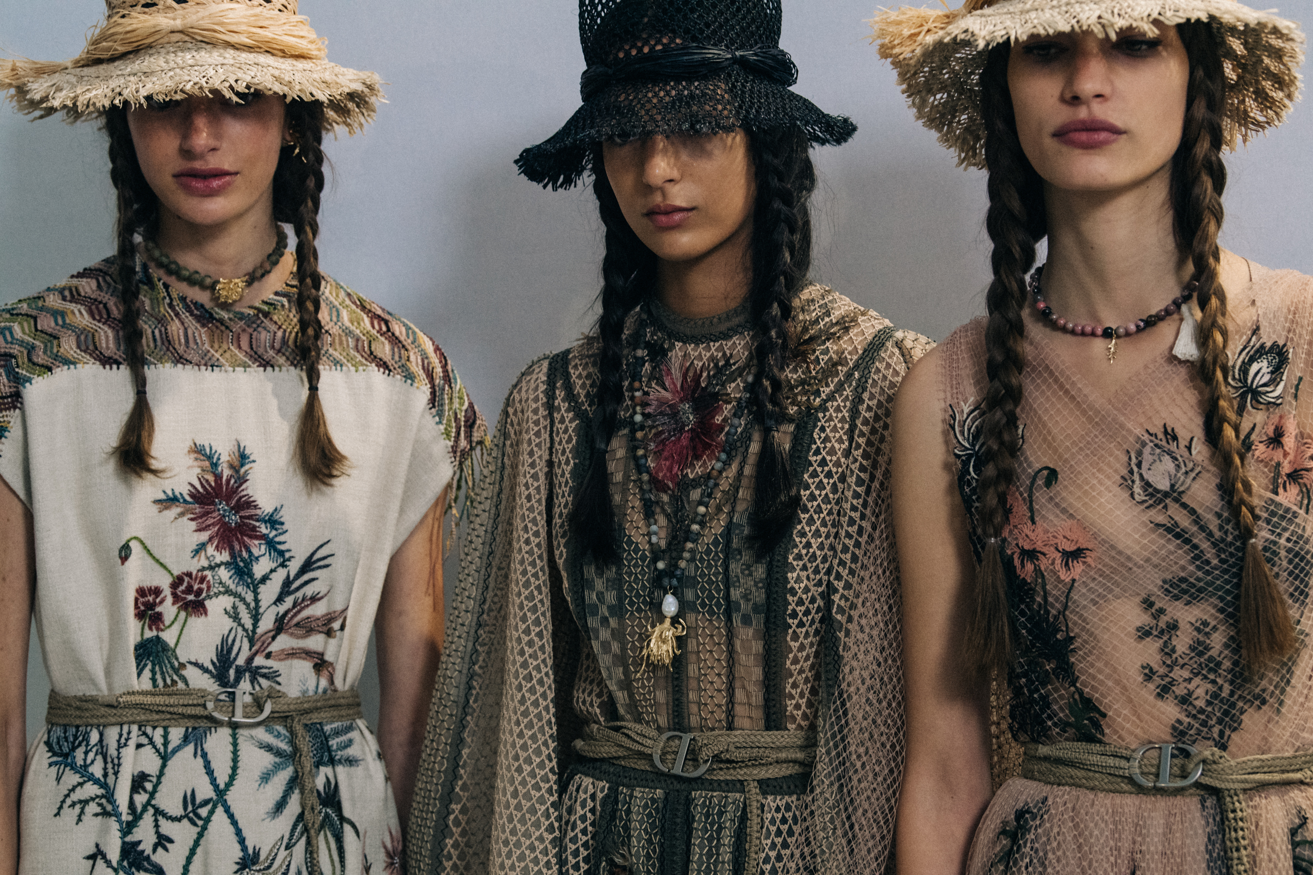 Models wearing straw hats at Christian Dior