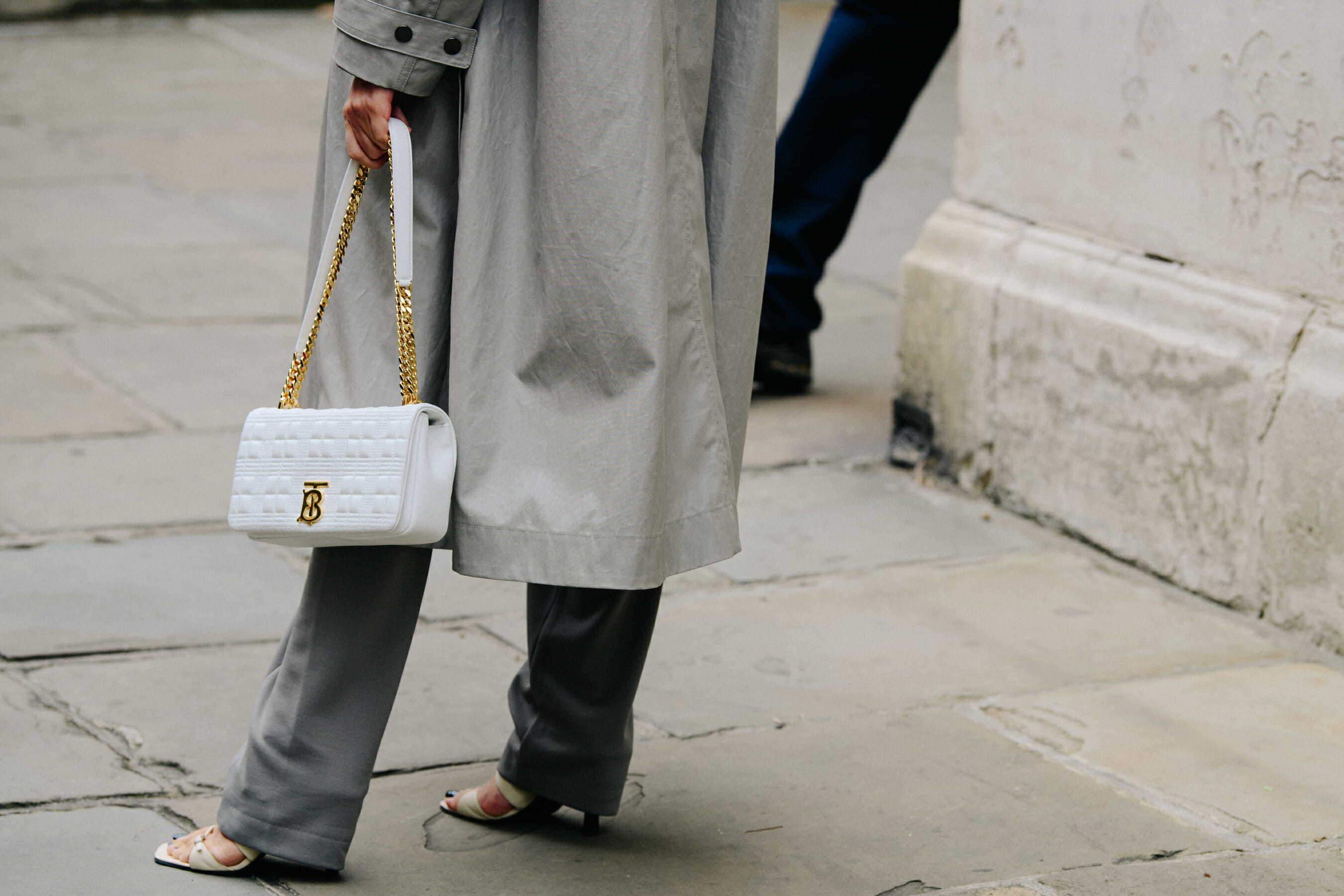 Woman carrying white Burberry bag