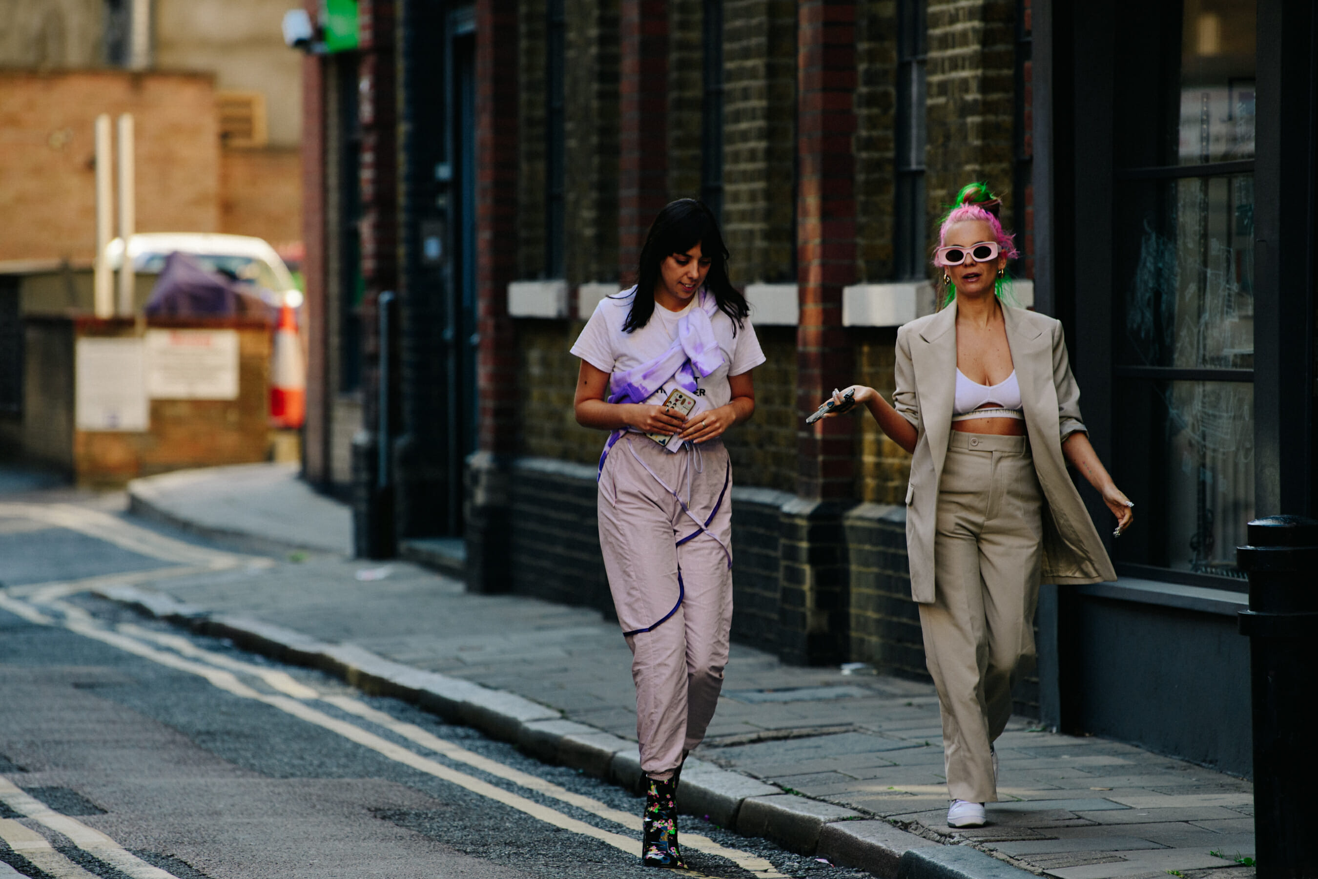 Two women wearing light outfits