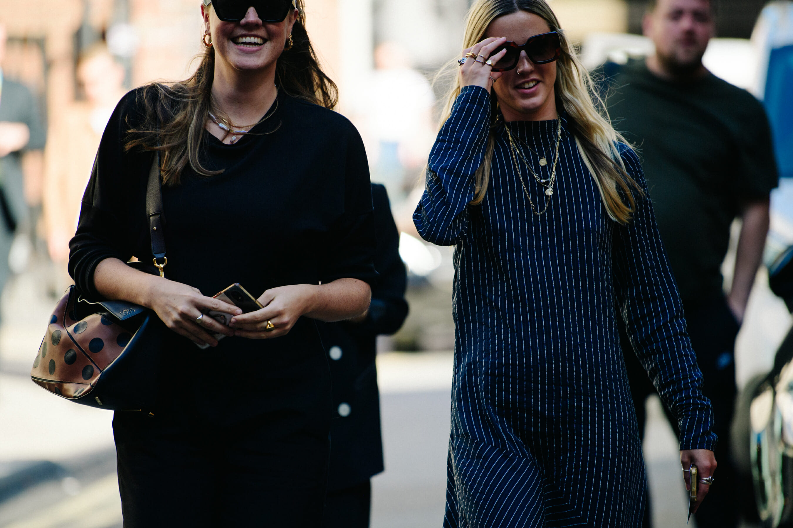 Two women wearing dark sunglasses