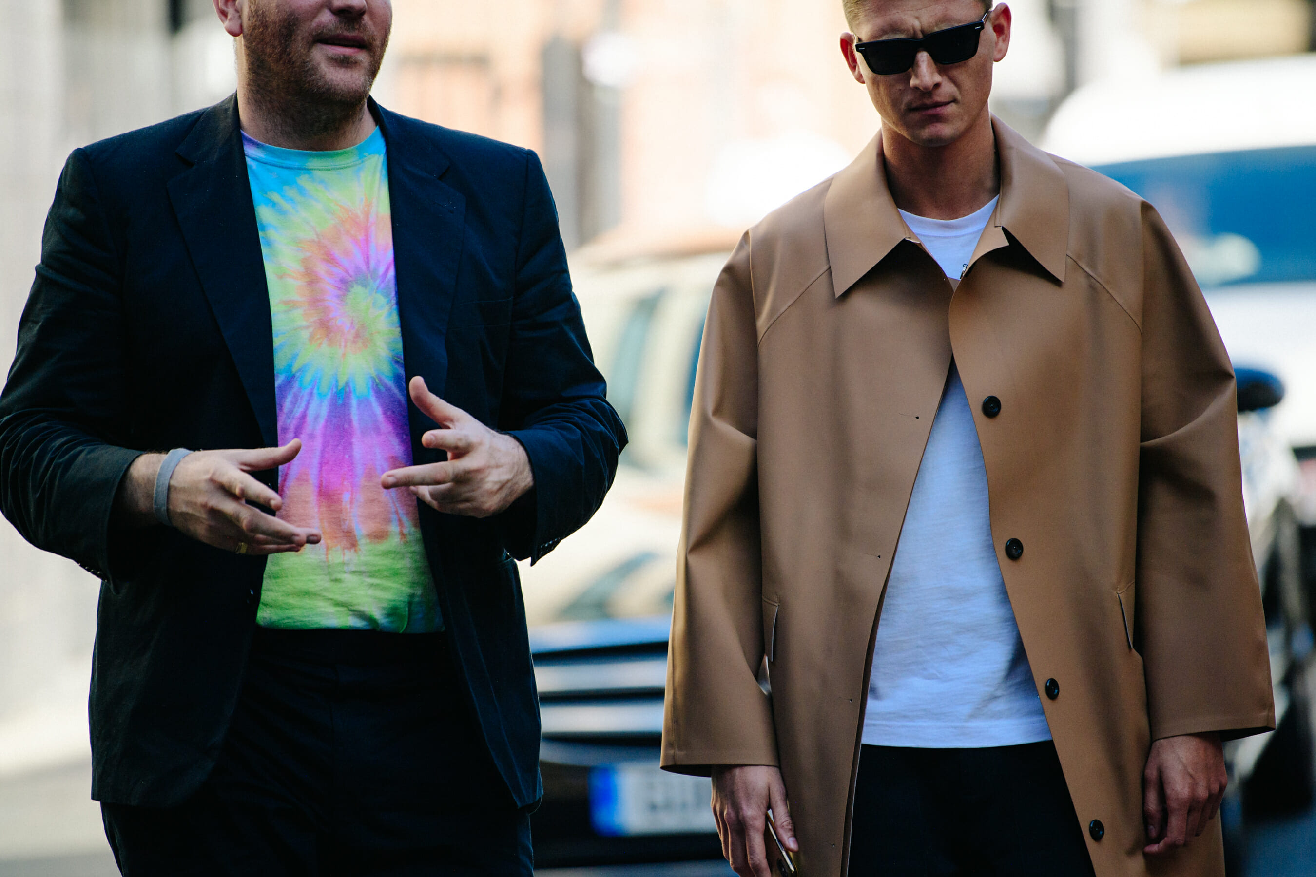 Two men wearing long coats