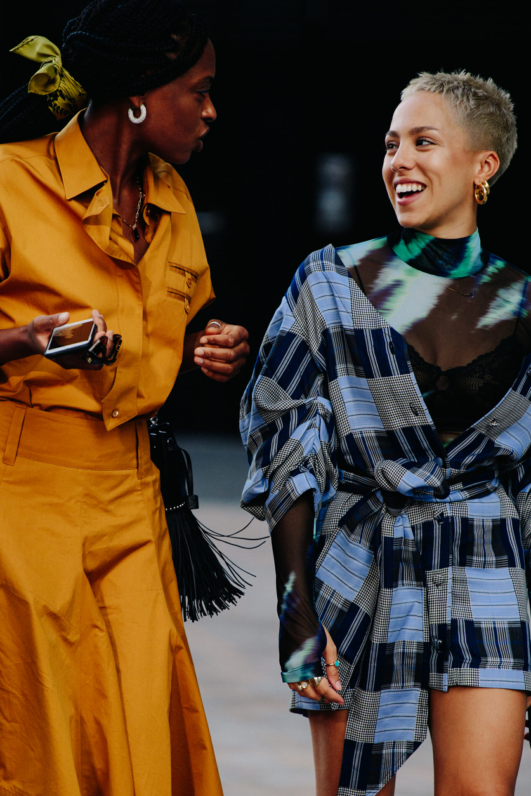 Two women wearing hoop earrings