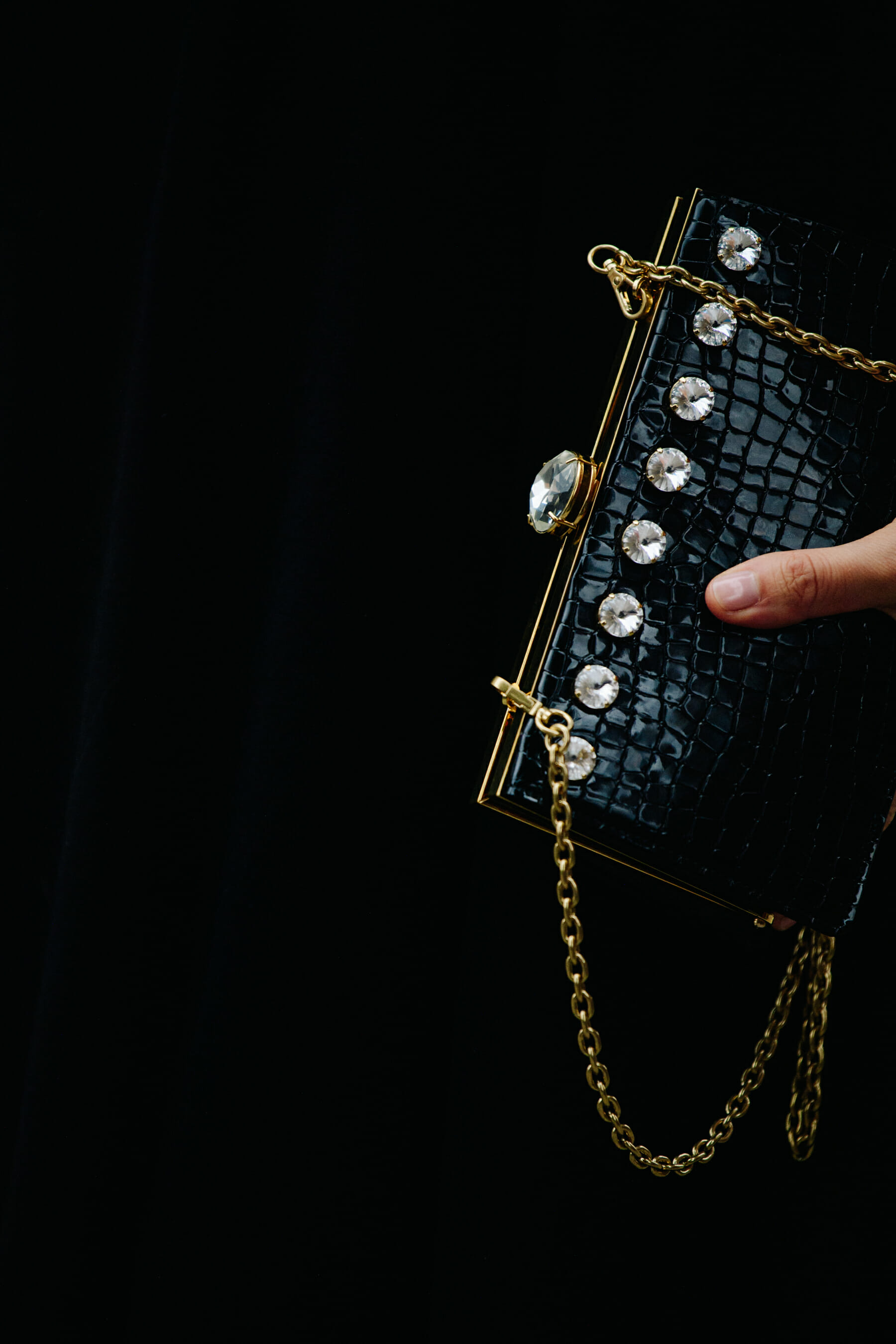 Woman carrying black handbag