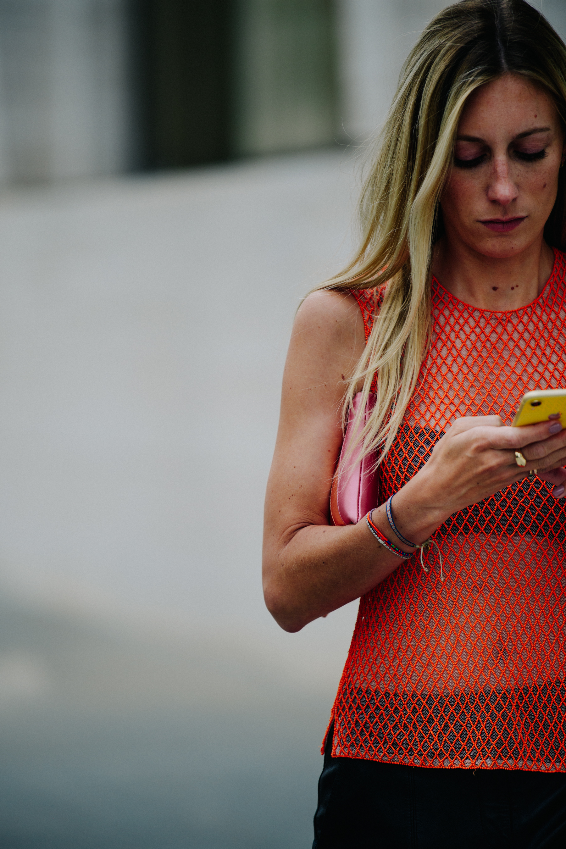 Woman wearing orange net vest