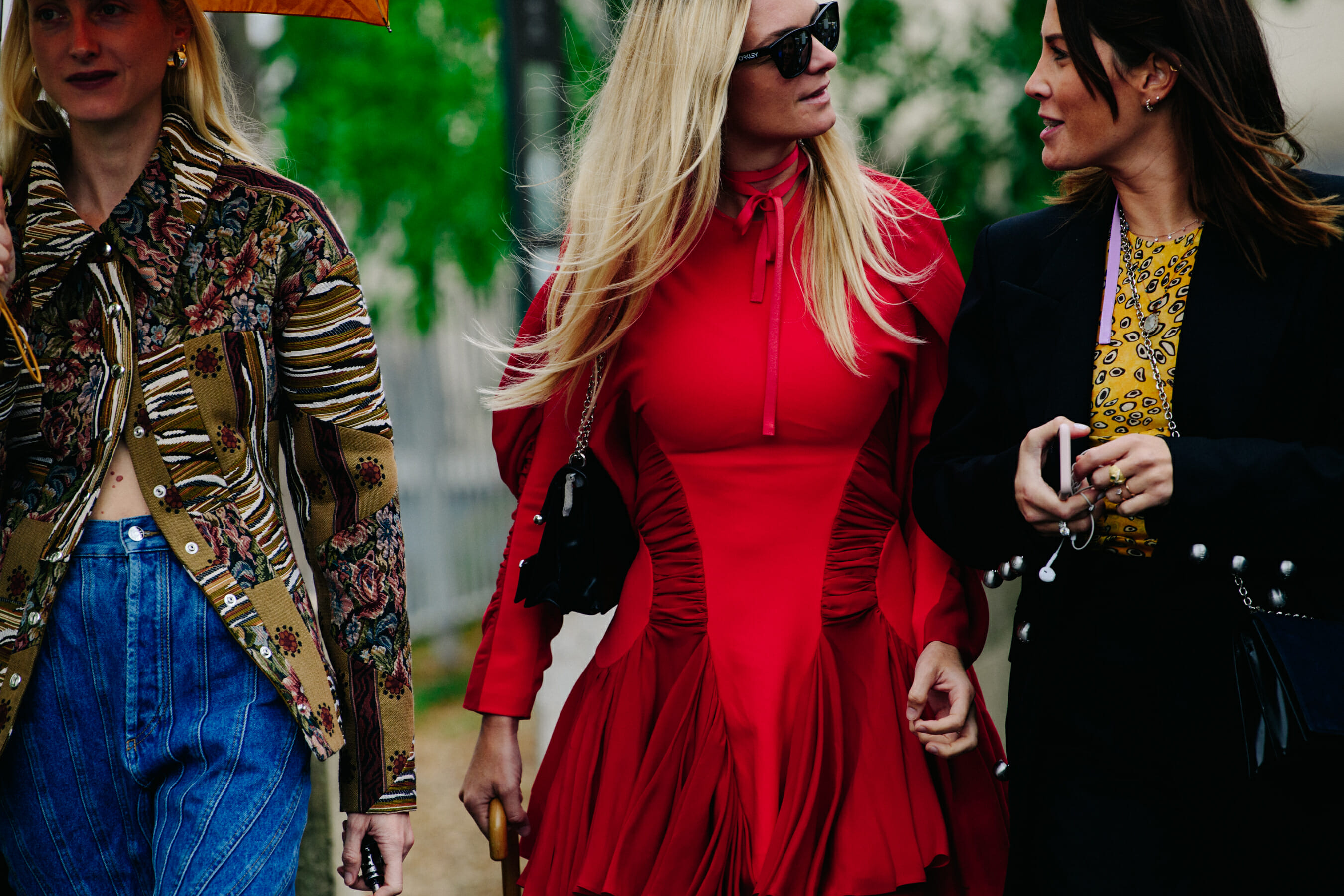 Three women wearing stylish clothing