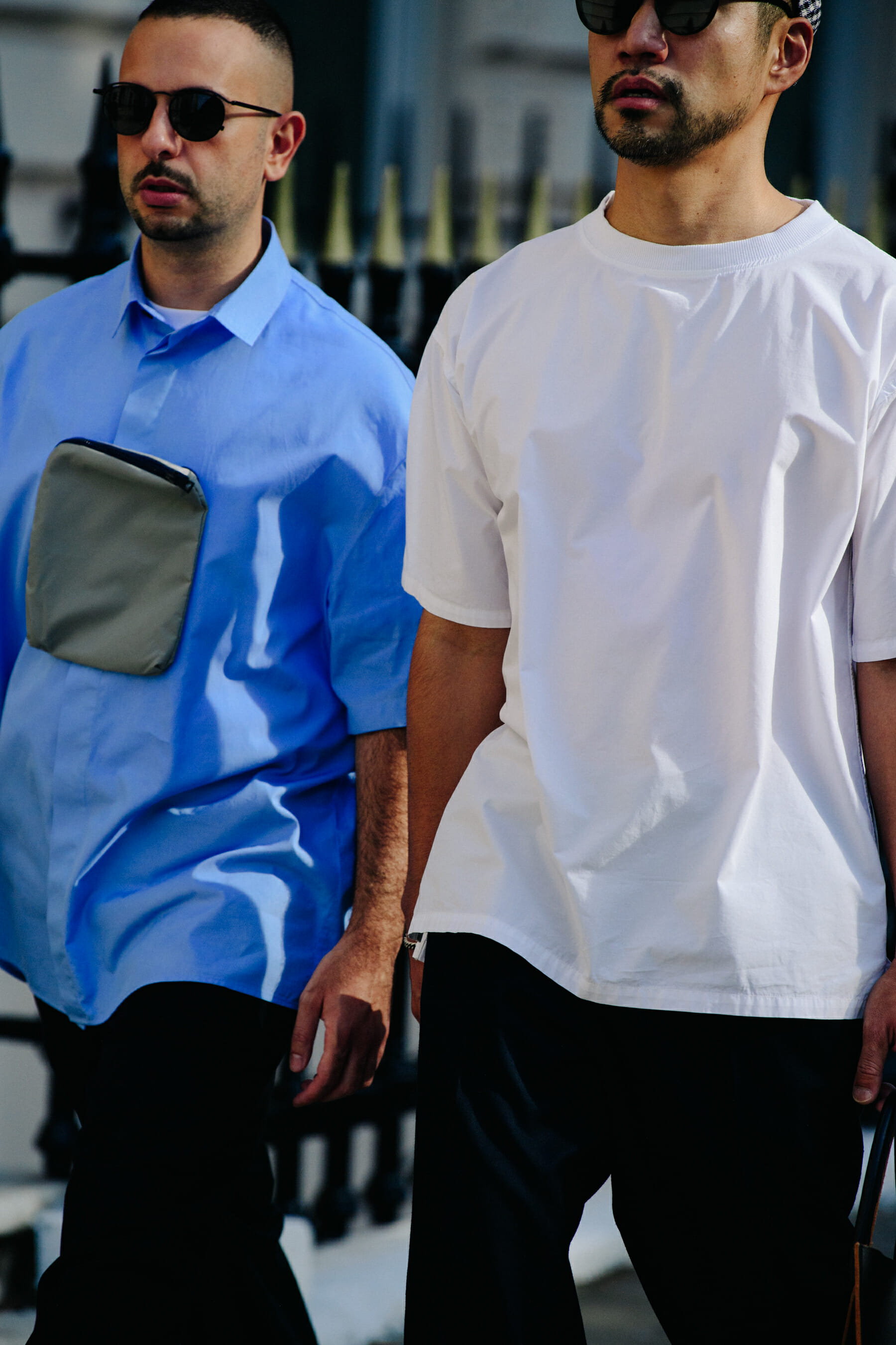 Two men wearing white and blue shirts