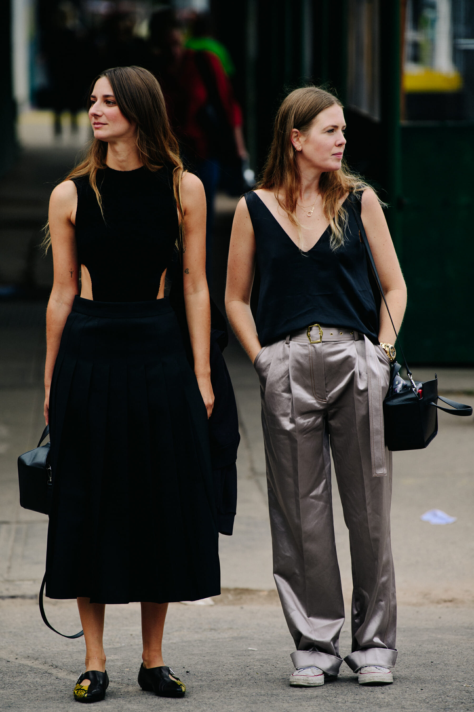 Two women wearing dark coats