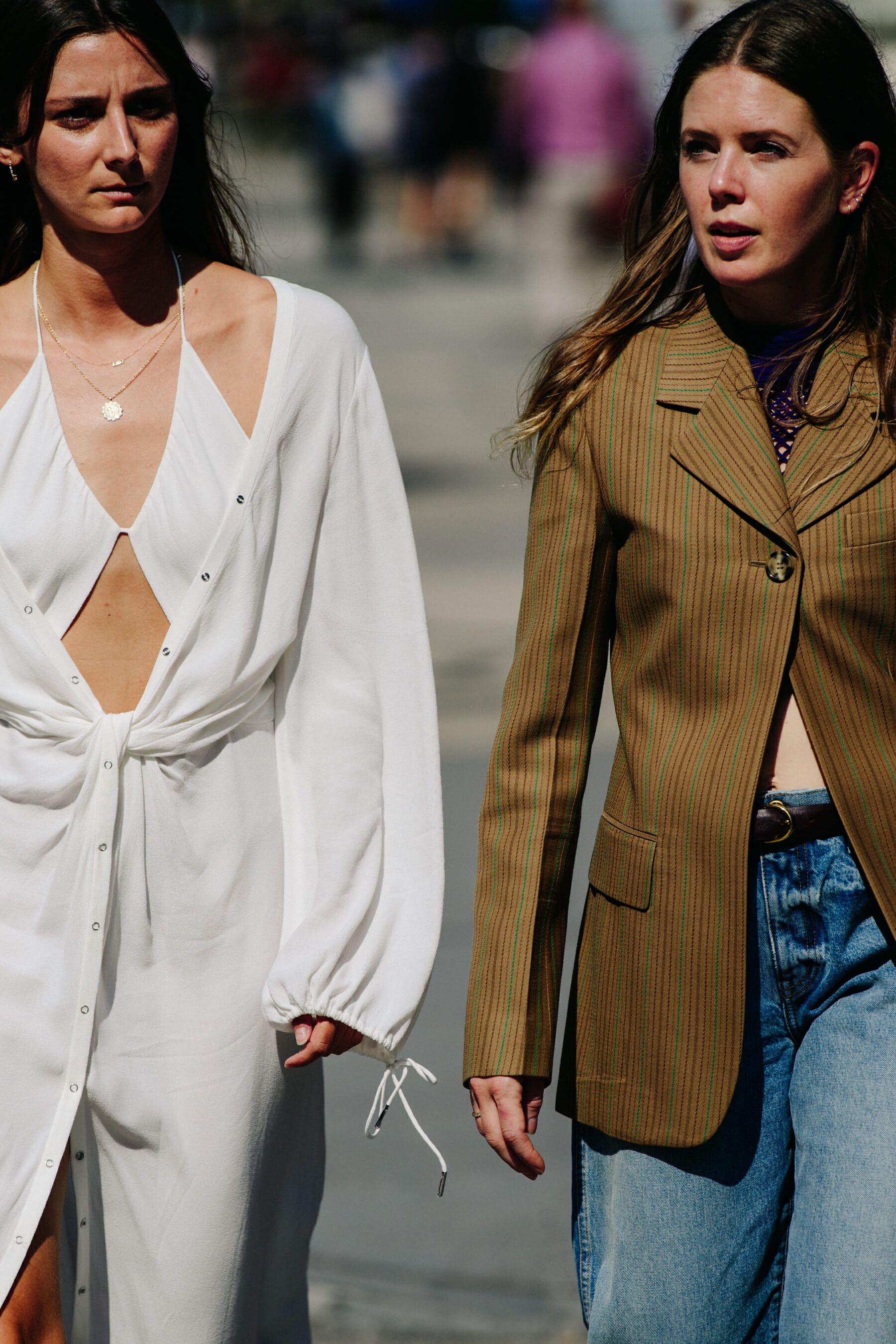 Two women wearing white and brown