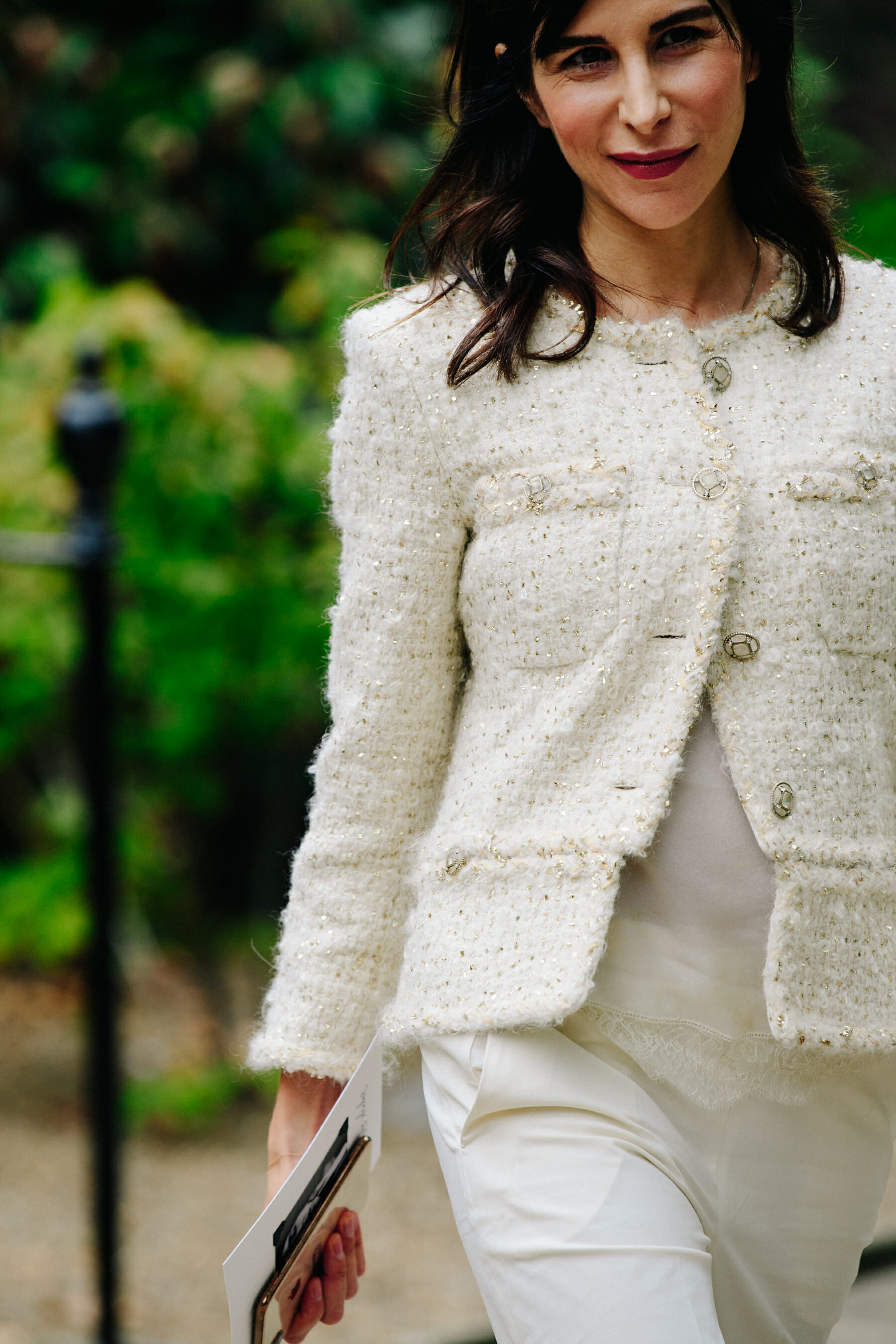 Woman wearing white Chanel jacket