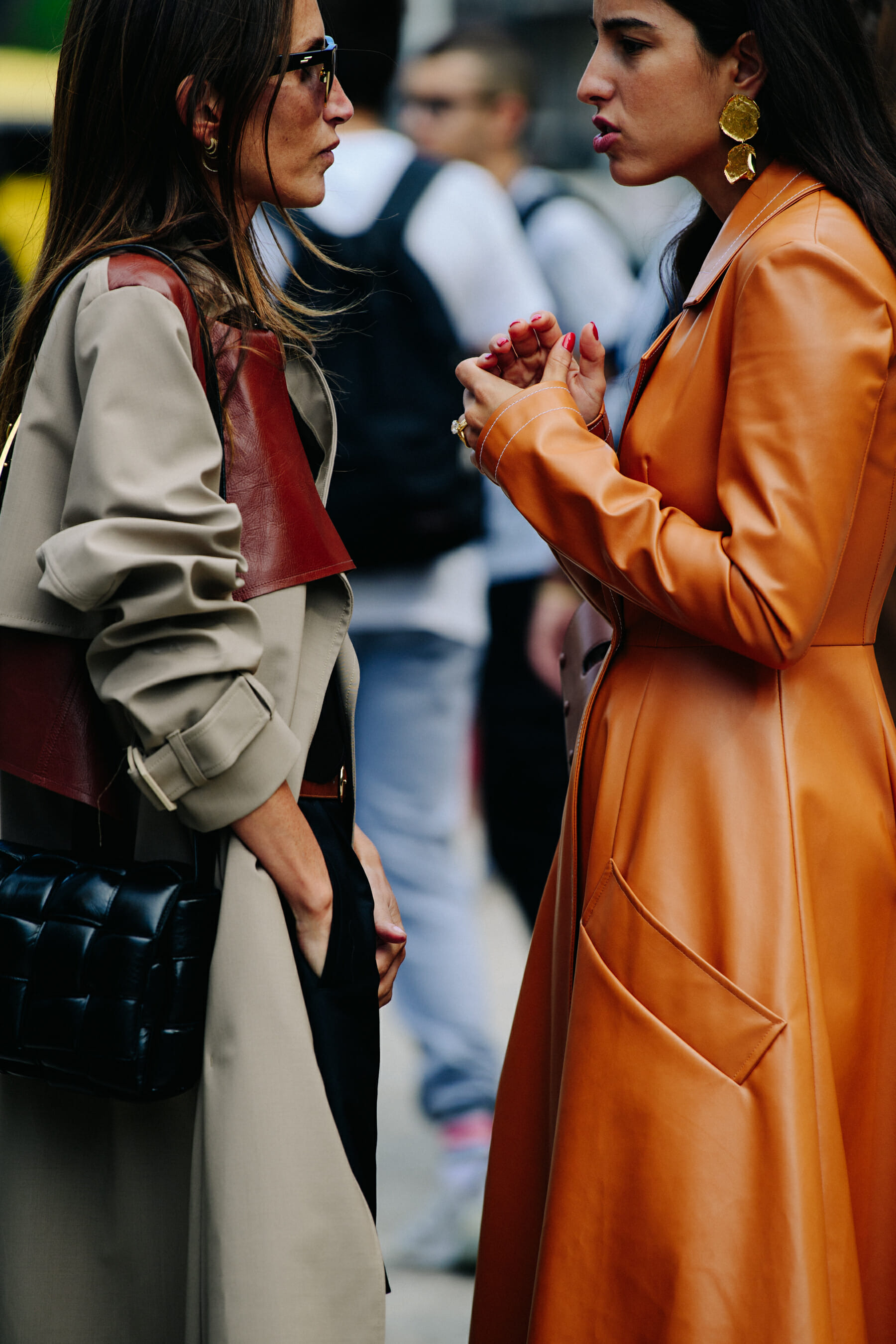 Two women wearing long coats