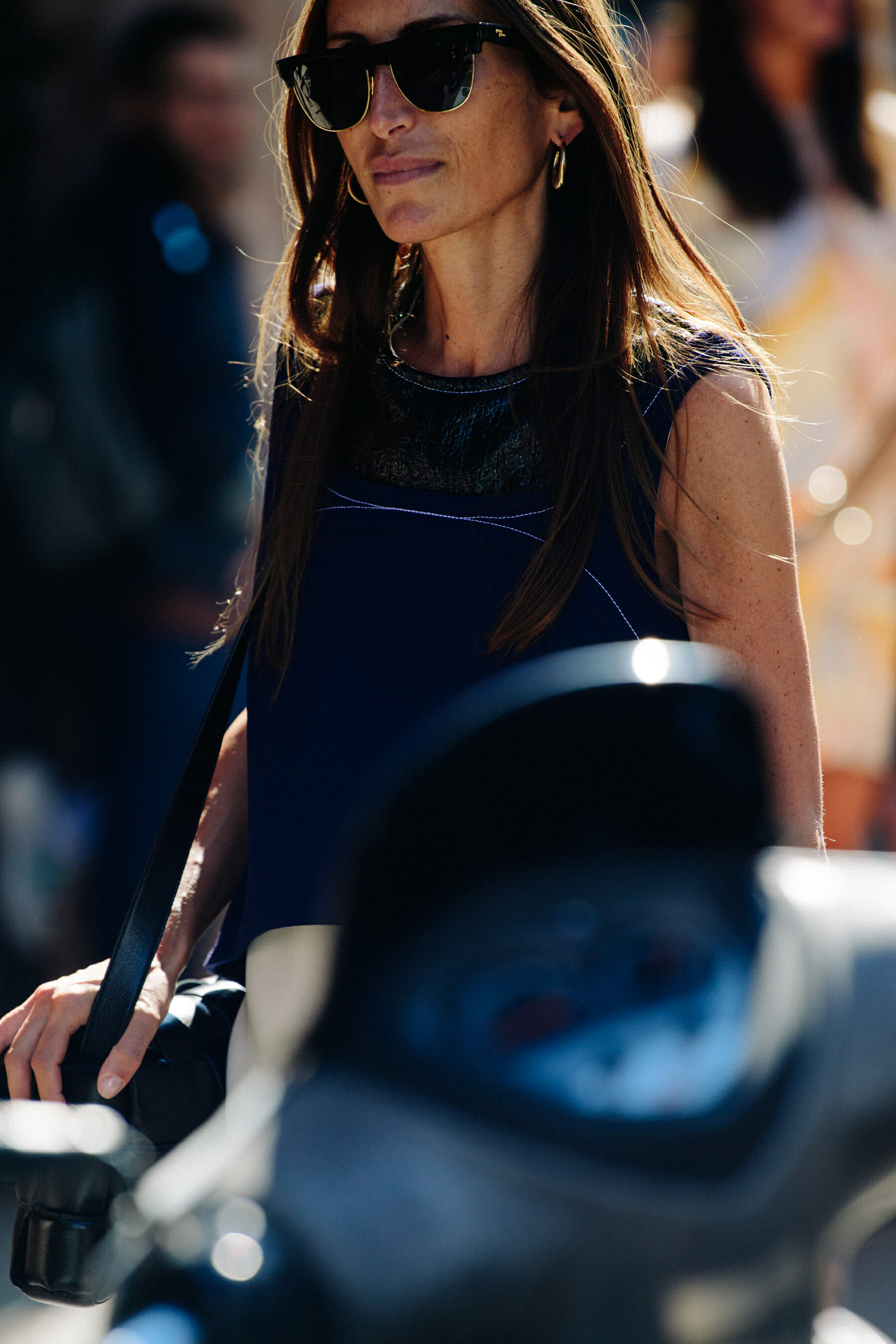 Woman wearing large gold sunglasses