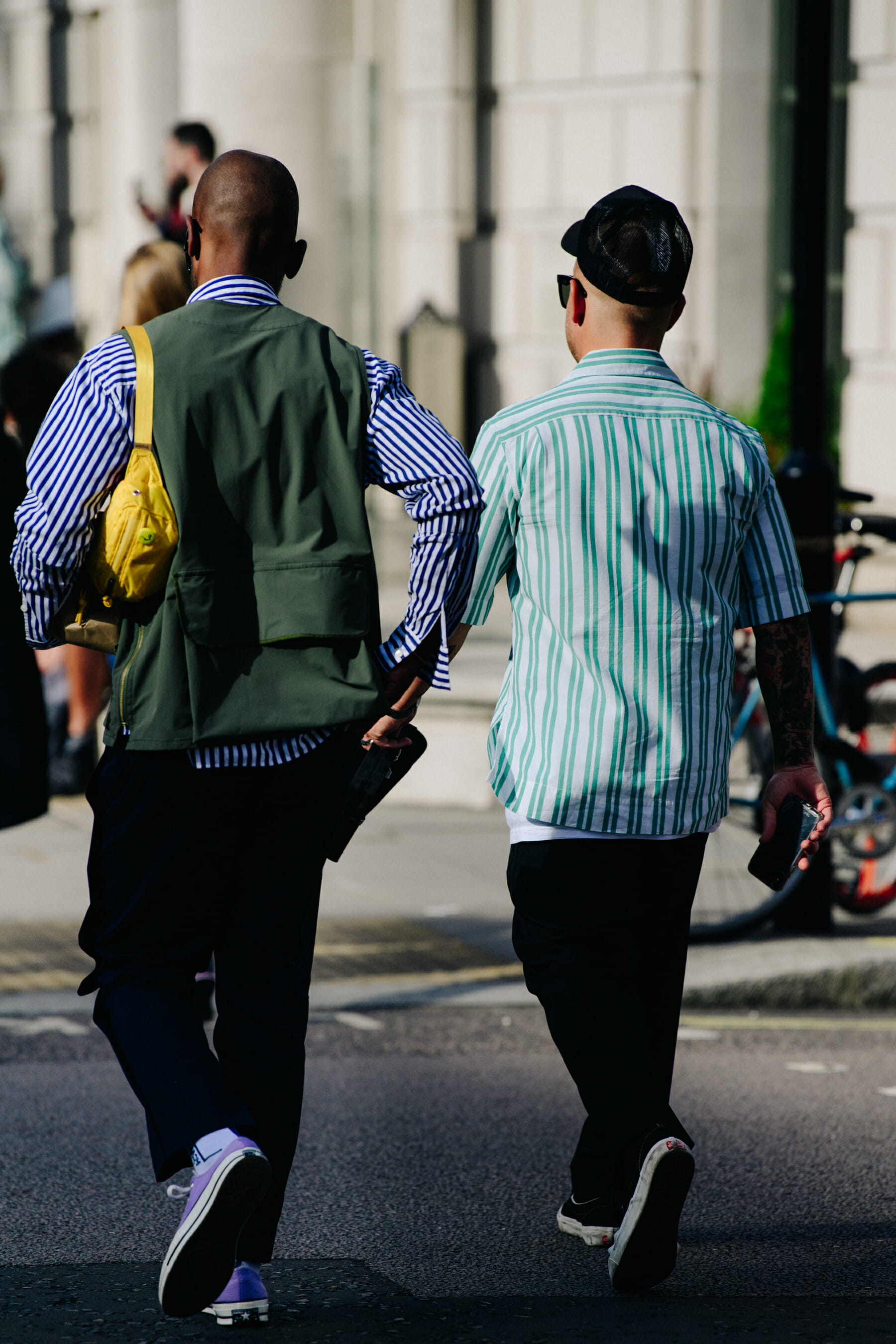 Two men wearing striped shirts