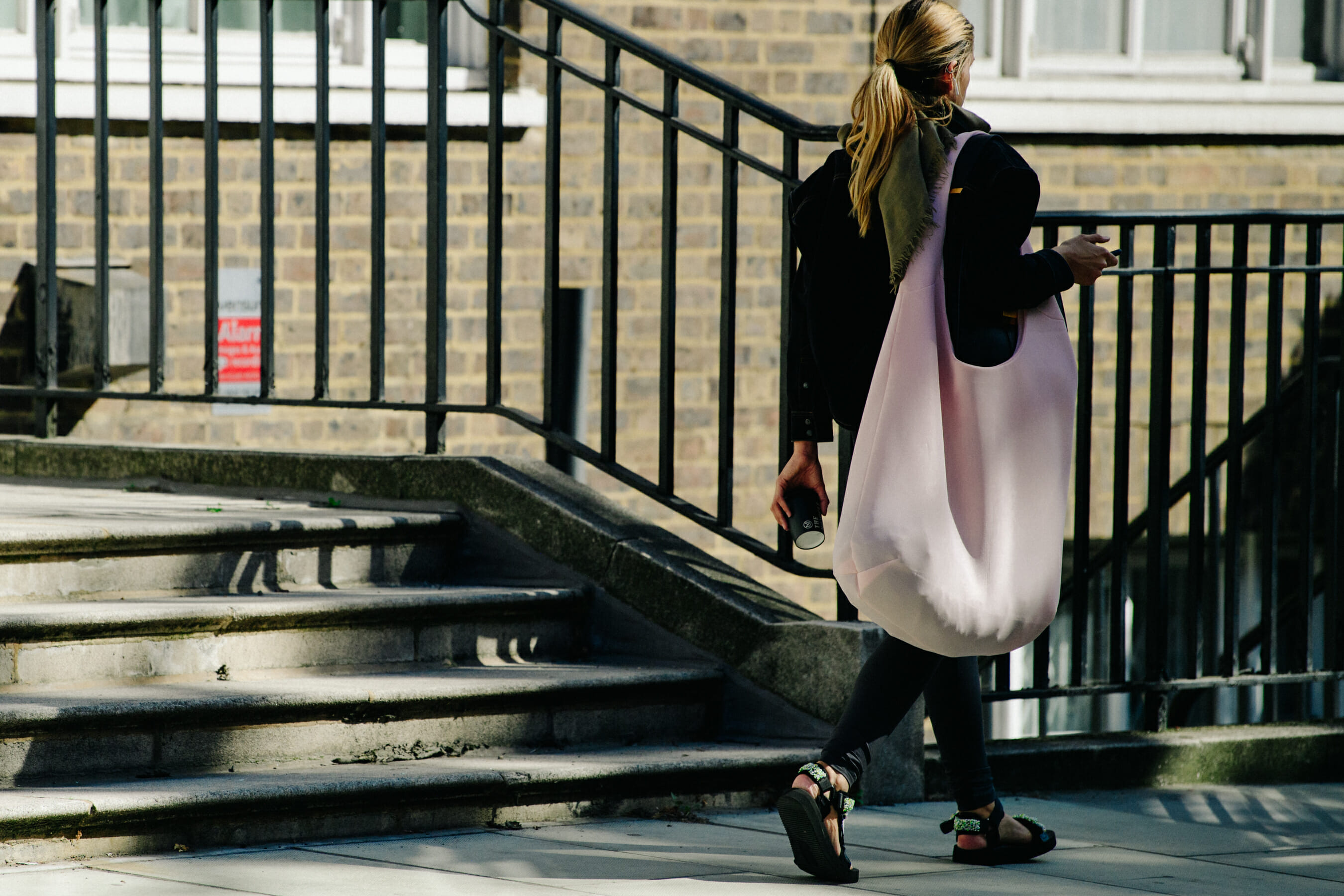 Woman carrying giant pink bag