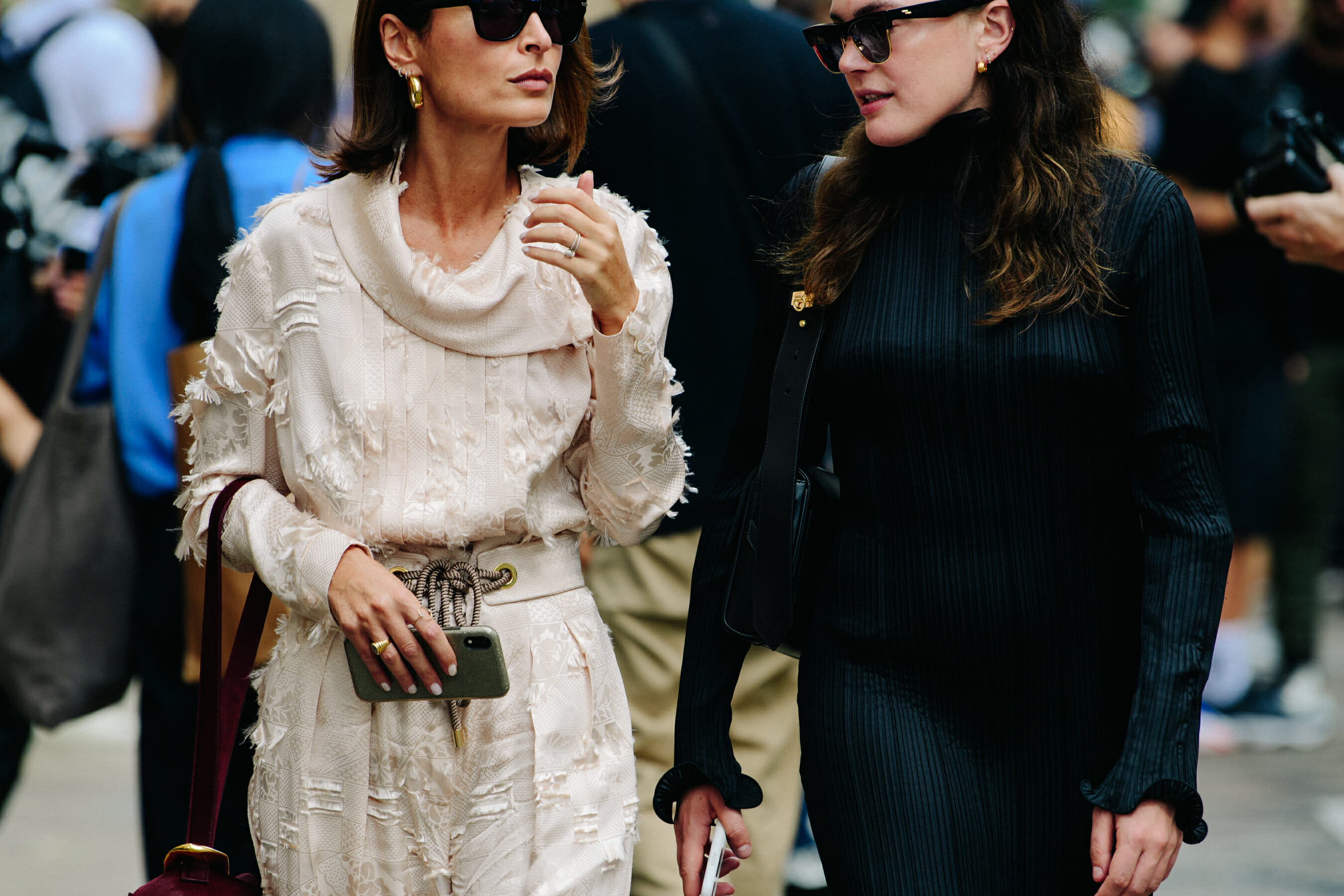 Two women wearing contrasting outfits