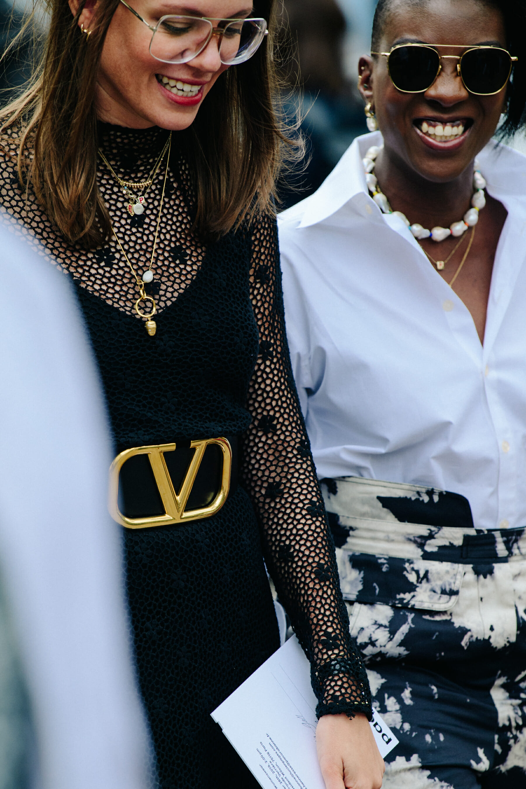 Two women wearing white and black