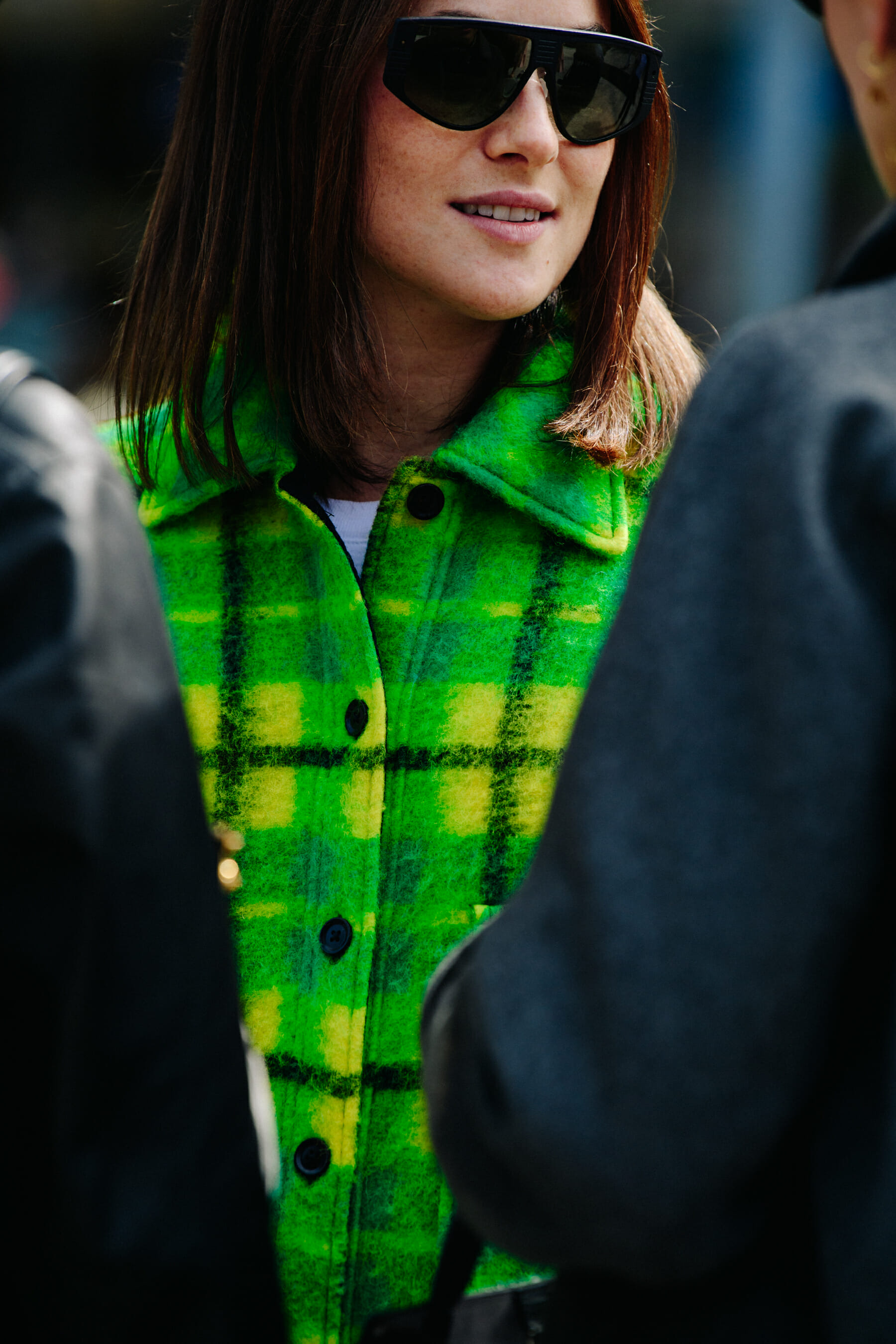 Woman wearing green check jacket